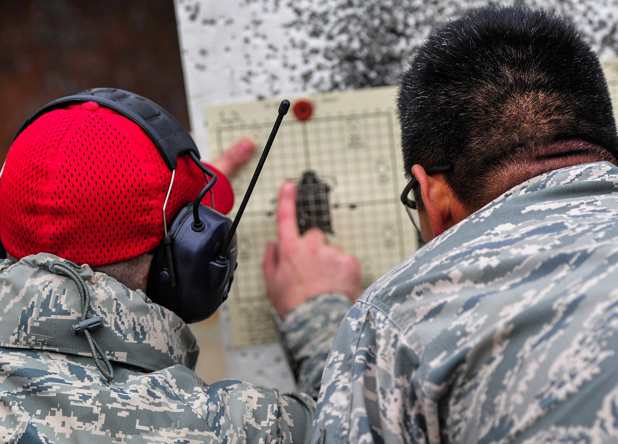 Staff Sgt. Casey Paine, 1st Special Operations Security Forces Squadron Combat Arms Training and Maintenance instructor, gives sight adjustment advice for the M4 rifle during small arms training at Hurlburt Field, Fla., Nov. 13, 2014. CATM instructors train and qualify Airmen on required weapons needed for deployments. (U.S. Air Force photo/Airman 1st Class Jeff Parkinson)