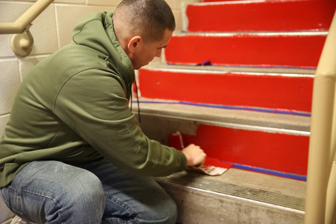 1st Lt. Edwin Roman paints steps in barracks 4295 at Marine Corps Air Station Cherry Point, N.C., Nov. 25, 2014. Staff noncommissioned officers and officers of Marine Air Control Group 28 cleaned and renovated the barracks in an effort to give back to the Marines during the holiday season. The Marines worked on various projects including, painting, landscaping and fixing furniture. Roman is a communications officer with Marine Air Support Squadron 1. 