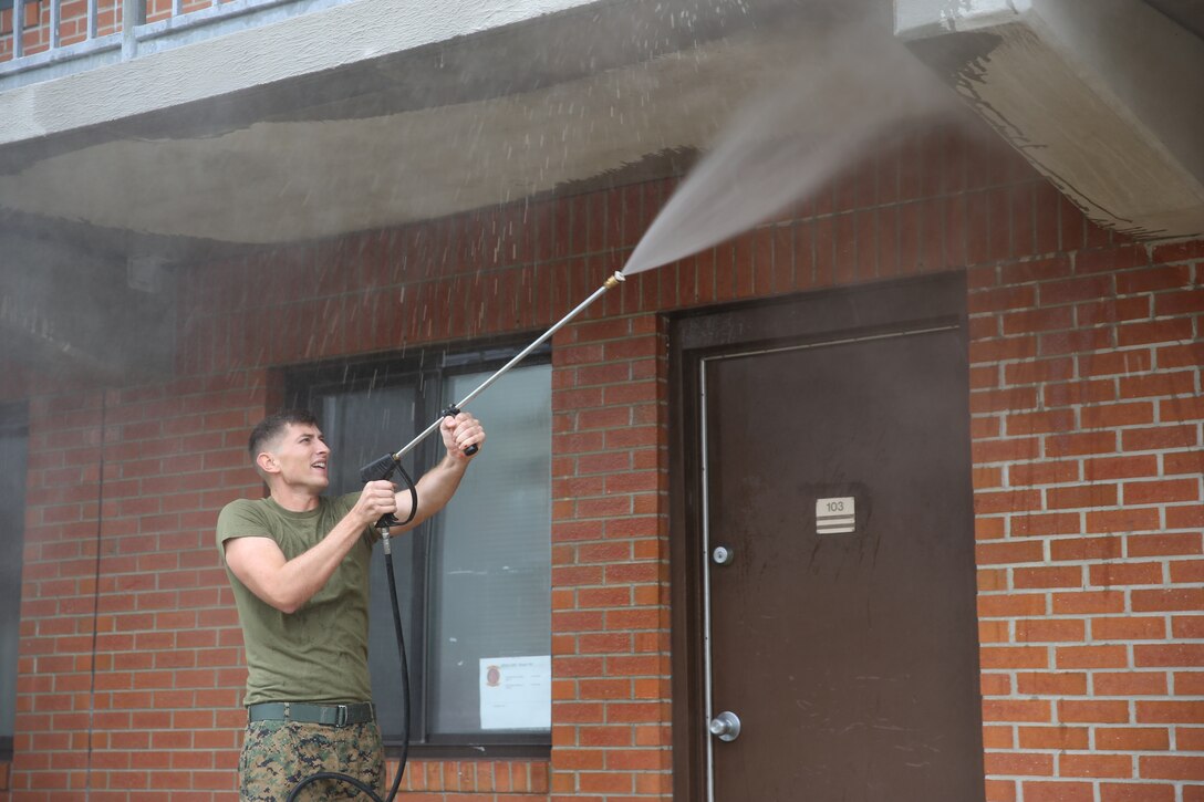 Maj. John Krysa rakes outside barracks 4295 at Marine Corps Air Station Cherry Point, N.C., Nov. 25 2014. Staff noncommissioned officers and officers worked together to clean and improve the living conditions for Marines in the barracks before the holiday season. The Marines cleaned the barracks in an effort to give back to the junior Marines during this holiday season. Krysa is the executive officer of Marine Air Control squadron 2. 