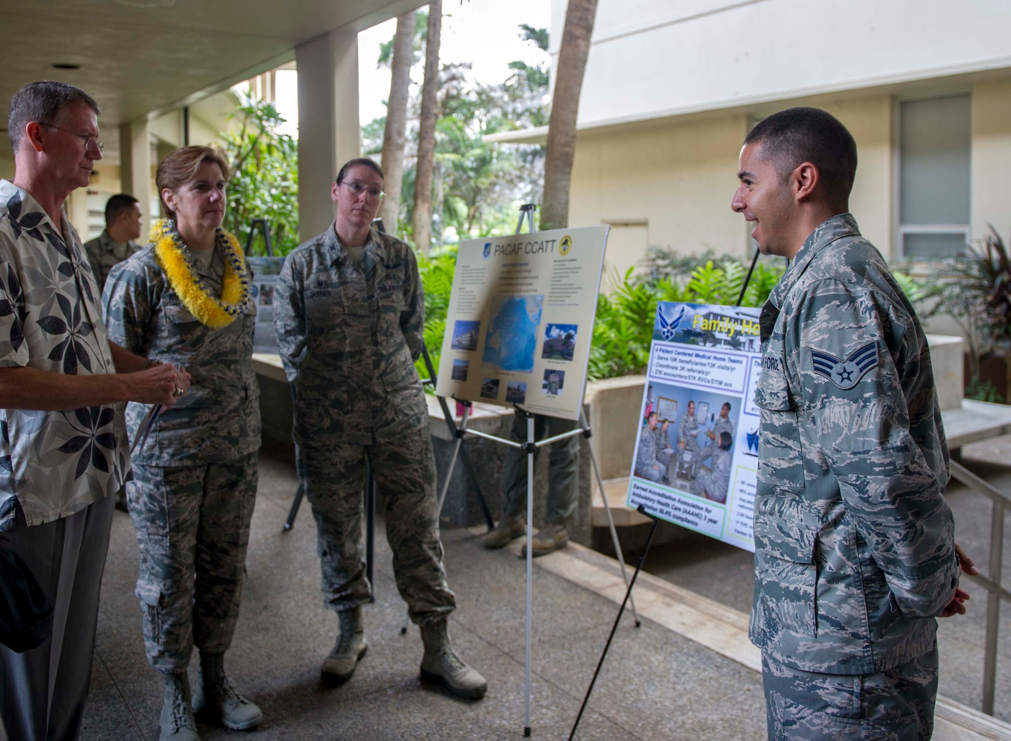 Senior Airman Daniel Sanders, 15th Medical Group aerospace medical technician, briefs Gen. Lori Robinson, Pacific Air Forces commander, and her husband Maj. Gen. David Robinson (USAF –Ret.) during a visit to the 15th MDG on Joint Base Pearl Harbor-Hickam, Hawaii, Nov. 25, 2014. General Robinson conducted her initial base tour to gain a better understanding of unit readiness and base capabilities and services while interacting with Airmen face-to-face. (U.S. Air Force photo by Tech. Sgt. Terri Paden/RELEASED)