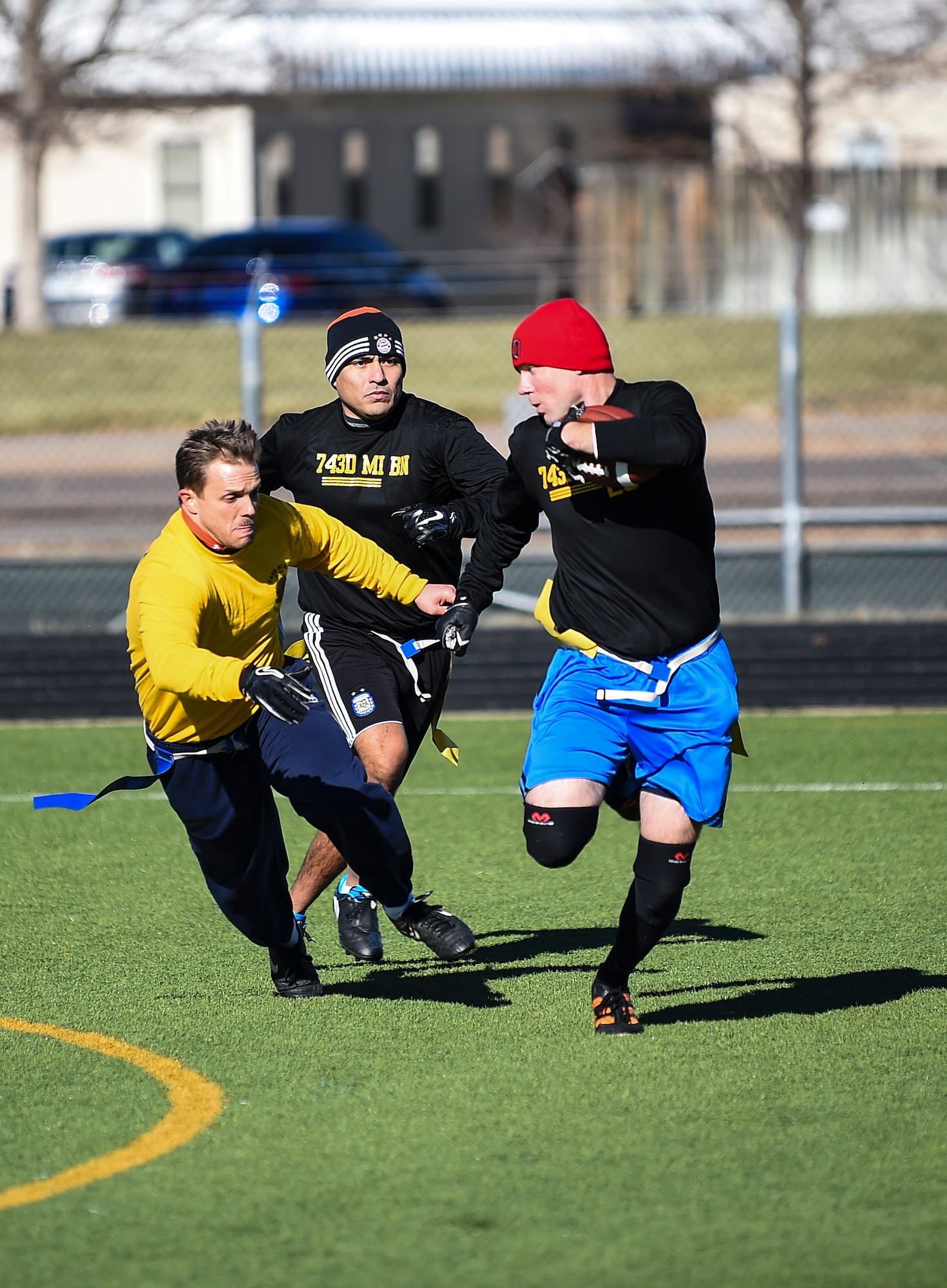 Soldiers from the 743rd Military Intelligence Battalion scramble on the field during their 2nd Annual Turkey Bowl football game Nov. 26, 2014 at the multipurpose field on Buckley Air Force Base, Colo. The officers challenged the NCOs during their pre-Thanksgiving game. (U.S. Air Force photo by Senior Airman Riley Johnson/Released)