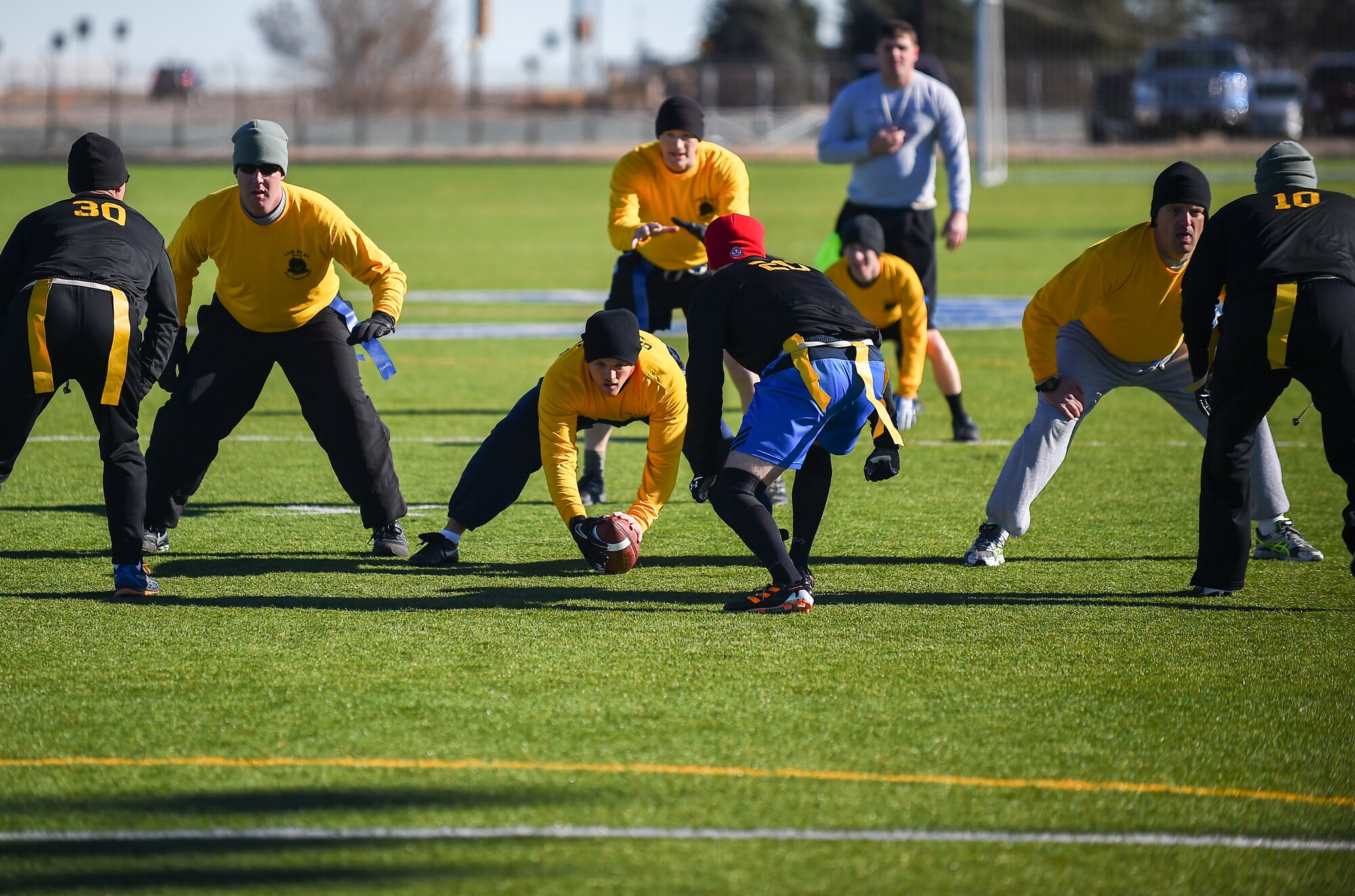 Soldiers from the 743rd Military Intelligence Battalion move into position during their 2nd Annual Turkey Bowl football game Nov. 26, 2014 at the multipurpose field on Buckley Air Force Base, Colo. The officers challenged the NCOs during their pre-Thanksgiving game. (U.S. Air Force photo by Senior Airman Riley Johnson/Released)