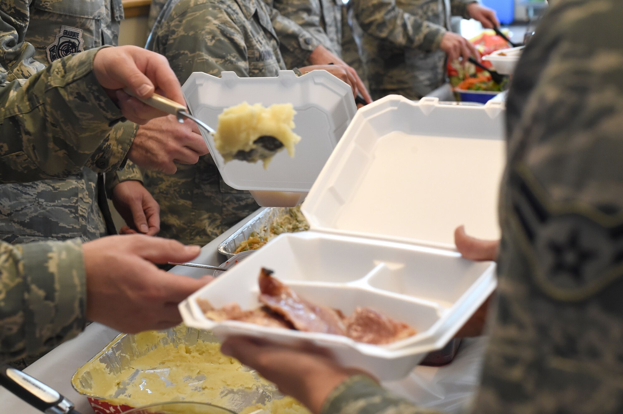 Panther Hall dorm residents are served a Thanksgiving meal prepared by leadership Nov. 26, 2014, on Buckley Air Force Base, Colo. The senior leaders served turkey, mashed potatoes, green bean casserole and other Thanksgiving dishes to the Airman. (U.S. Air Force photo by Airman 1st Class Samantha Saulsbury/Released)
