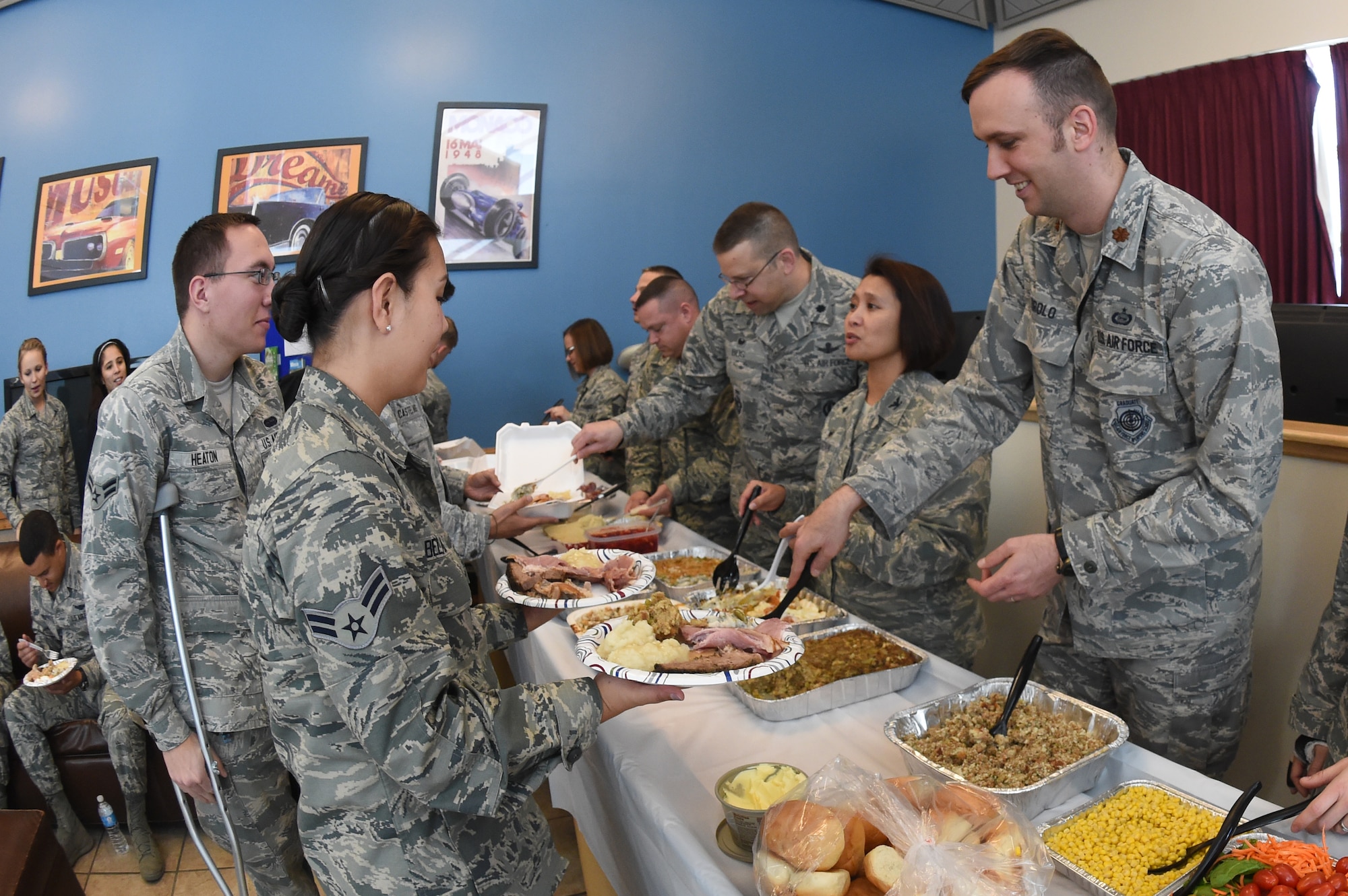 Team Buckley senior leaders serve dorm residents a Thanksgiving meal Nov. 26, 2014, on Buckley Air Force Base, Colo.  The senior leaders served turkey, mashed potatoes, green bean casserole and other Thanksgiving dishes to the Airman. (U.S. Air Force photo by Airman 1st Class Samantha Saulsbury/Released)