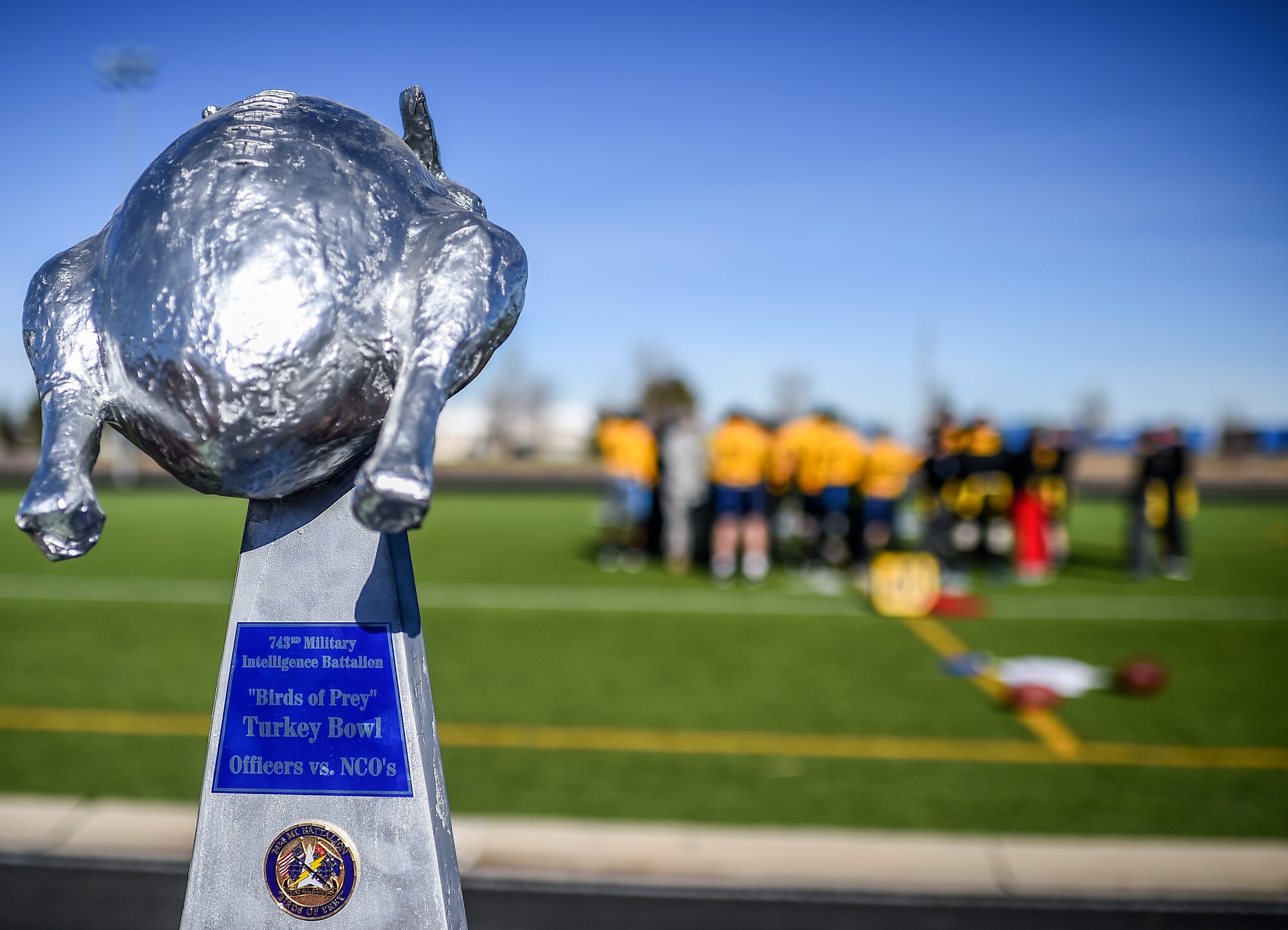 Soldiers from the 743rd Military Intelligence Battalion discuss the rules for their 2nd Annual Turkey Bowl football game Nov. 26, 2014 at the multipurpose field on Buckley Air Force Base, Colo. The officers challenged the NCOs during their pre-Thanksgiving game. (U.S. Air Force photo by Senior Airman Riley Johnson/Released) 