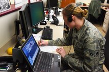 Airman 1st Class Samantha Collins, 341st Medical Operations Squadron pediatrics technician, uses a remote communication and monitoring system to talk with a medical technician during an Ebola exercise at the Malmstrom Air Force Base Clinic Nov. 25. As part of the exercise, various clinic personnel acted in first responder, medical aid and communication roles to support hand-off of the simulated Ebola patient to the proper facilities. (U.S. Air Force photo/Airman 1st Class Collin Schmidt)