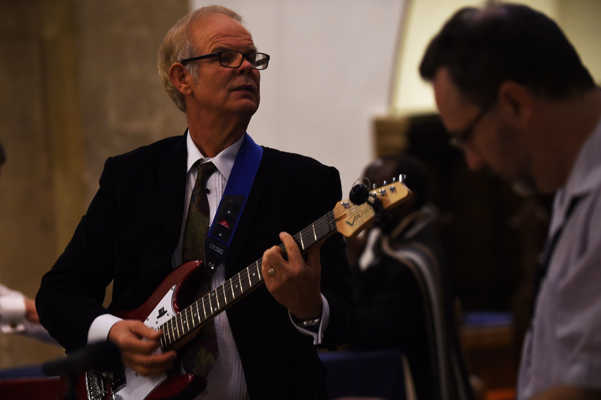 Rev. Dennis Niziol, plays guitar during the 2nd Annual British-American Thanksgiving Service at St. Edburg's Church, Bicester, England, Nov. 26, 2014. While this is the second year the local community has hosted a joint Thanksgiving service, it is the 20th year Airmen from RAF Croughton celebrated an Ecumenical Thanksgiving event. (U.S. Air Force photo by Staff Sgt. Jarad A. Denton/Released)