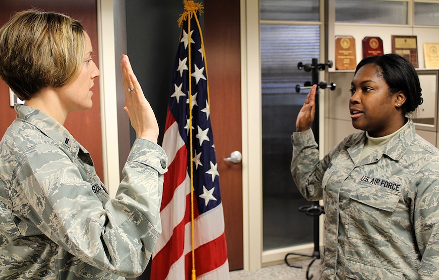 She signed for two more years!  First Lt. Liz Wszalek performs the oath of enlistment for Staff Sgt. Reonna Ford who signed up for several additional years with the Air Force Reserve Command.  She was excited and happy during the short ceremony.  "The military has been an important part of my life for the last 8 years. I am honored to serve my country and decided to re-enlist for two more years. I am very thankful for the wonderful opportunities that  came with joining the Air Force. I have obtained my education, a great career, and met many wonderful people along the way," said Staff Sergeant Reonna Ford.  (U.S. Air Force photo/Maj. Stan Paregien)

