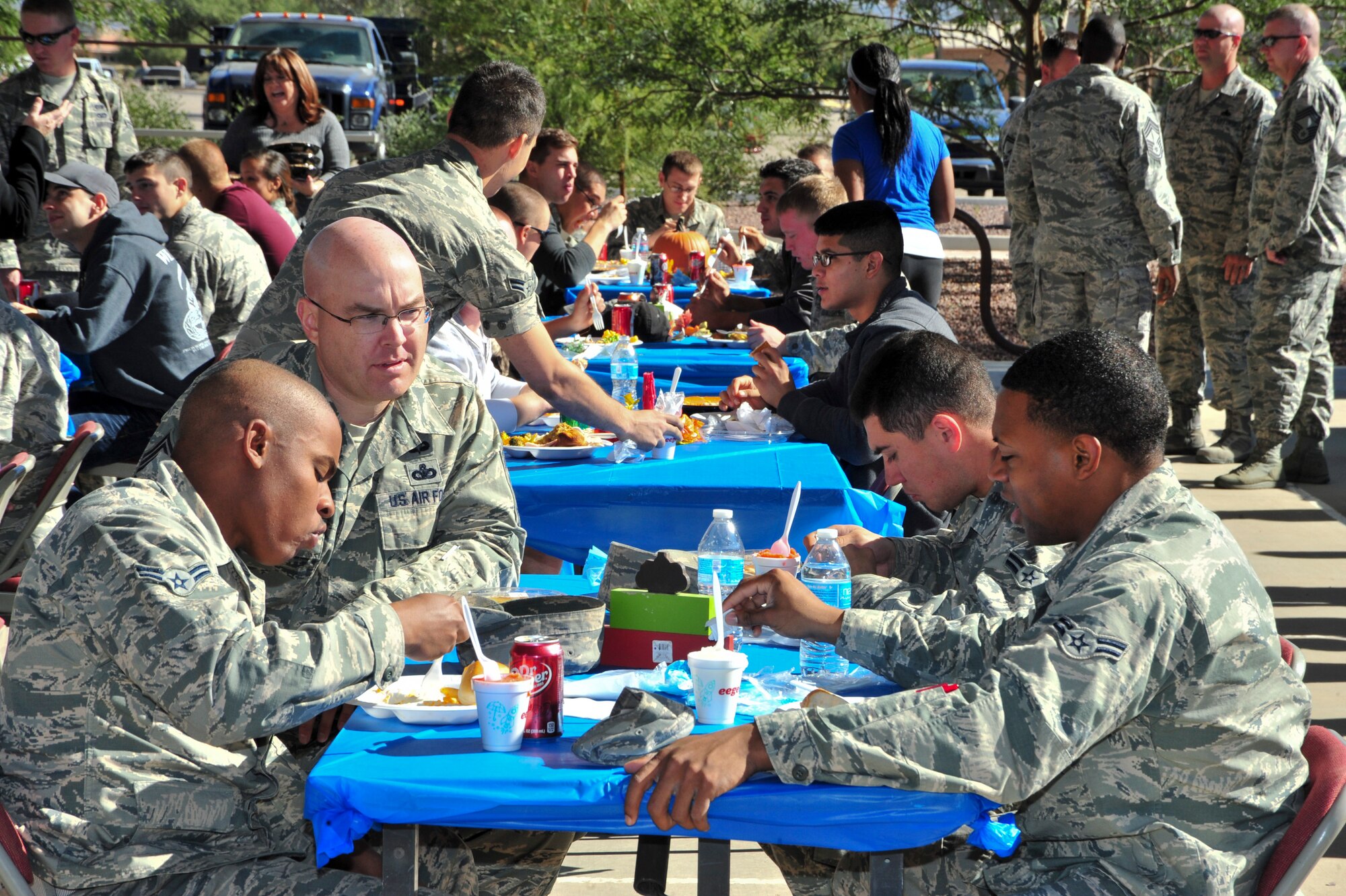 U.S. Air Force Chief Master Sgt. Ryan L. Peterson, 355th Fighter Wing command chief, speaks with Airmen during a Thanksgiving Dorm Bash held at Davis-Monthan Air Force Base, Ariz., Nov. 25, 2014.  This event allows senior leaders the chance to mingle and celebrate the holiday with dorm resident.  (U.S. Air Force Photo by Airman 1st Class Chris Massey/Released)