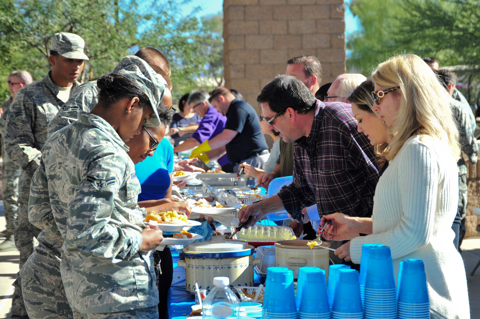 U.S. Air Force Airmen fill their plates during a Thanksgiving Dorm Bash held at Davis-Monthan Air Force Base, Ariz., Nov. 25, 2014.  The bash provided an opportunity for dorm residents to receive a home-cooked meal before the holidays.  (U.S. Air Force Photo by Airman 1st Class Chris Massey/Released)