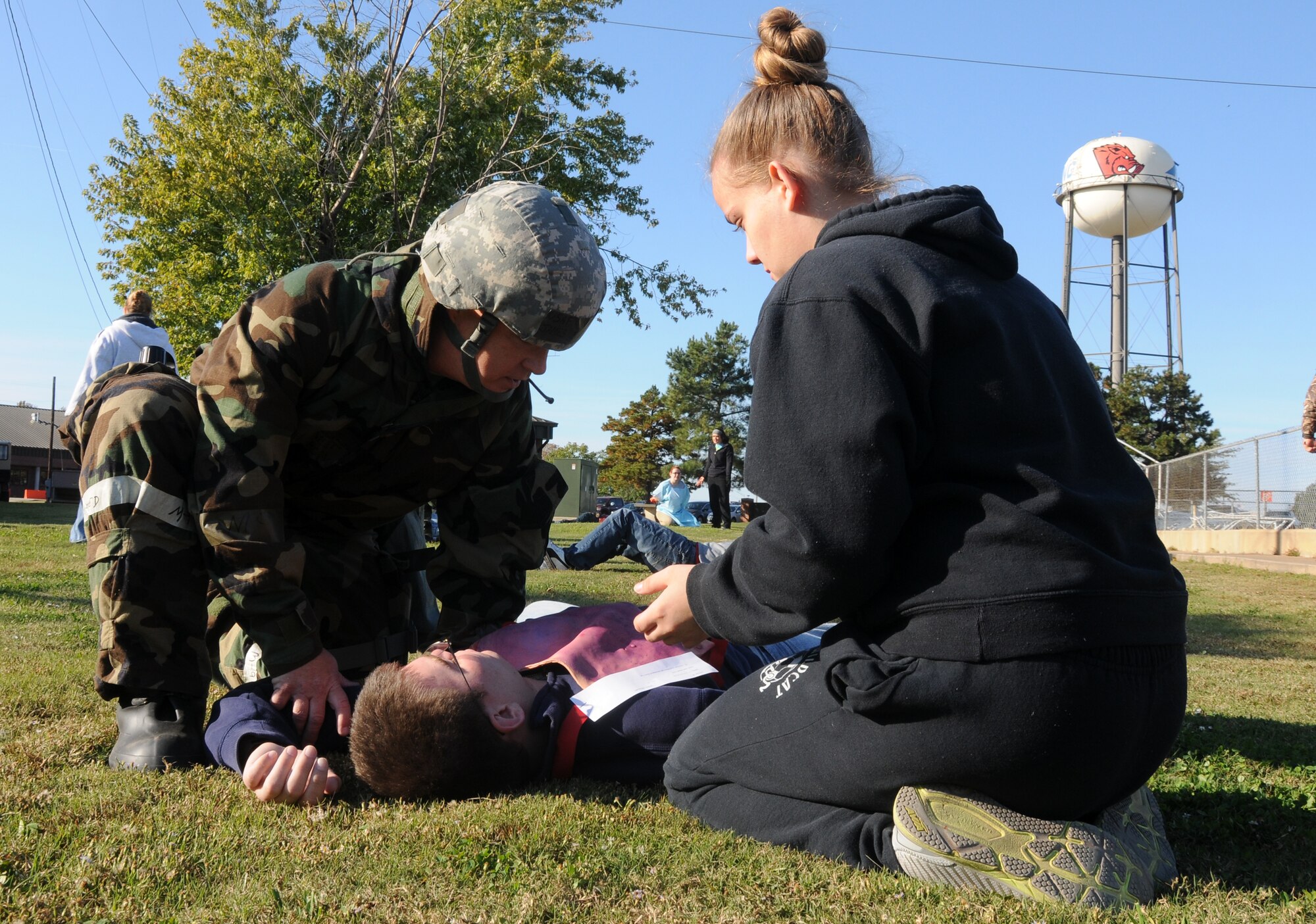 Airmen from the 188th Medical Group provide self-aid and buddy care for simulated injured wingmen during a mass casualty exercise at Ebbing Air National Guard Base, Fort Smith, Ark., Nov. 2, 2014. Student Flight Airmen volunteered to participate as casualties throughout the exercise. The purpose of the exercise was to test Airmen’s ability to triage personnel while facing possible attacks. (U.S. Air National Guard photo by Airman 1st Class Cody Martin/Released)