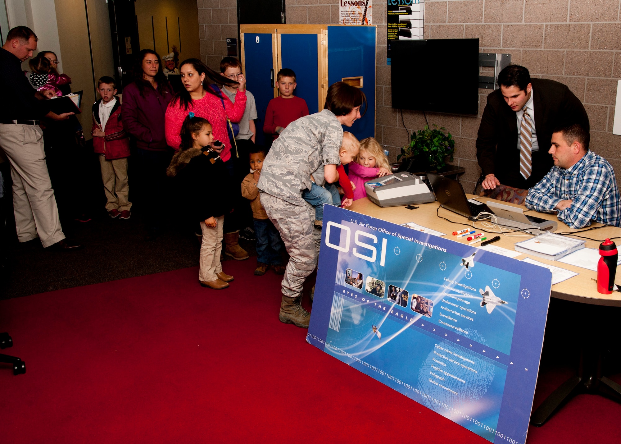 PETERSON AIR FORCE BASE, Colo. - Air Force Office of Special Investigators 8th Field Investigations Squadron, partnered with the U.S. Secret Service, conducted a community outreach event known as Operation Safe Kids at the RP Lee Youth Center, Nov. 20, 2014. Operation Safe Kids is a program by the U.S. Secret Service where parents are provided identification kits of their children’s basic information, photo and fingerprints. If the child goes missing the parents can quickly provide the information to law enforcement agencies. (U.S. Air Force photo by Senior Airman Tiffany DeNault)