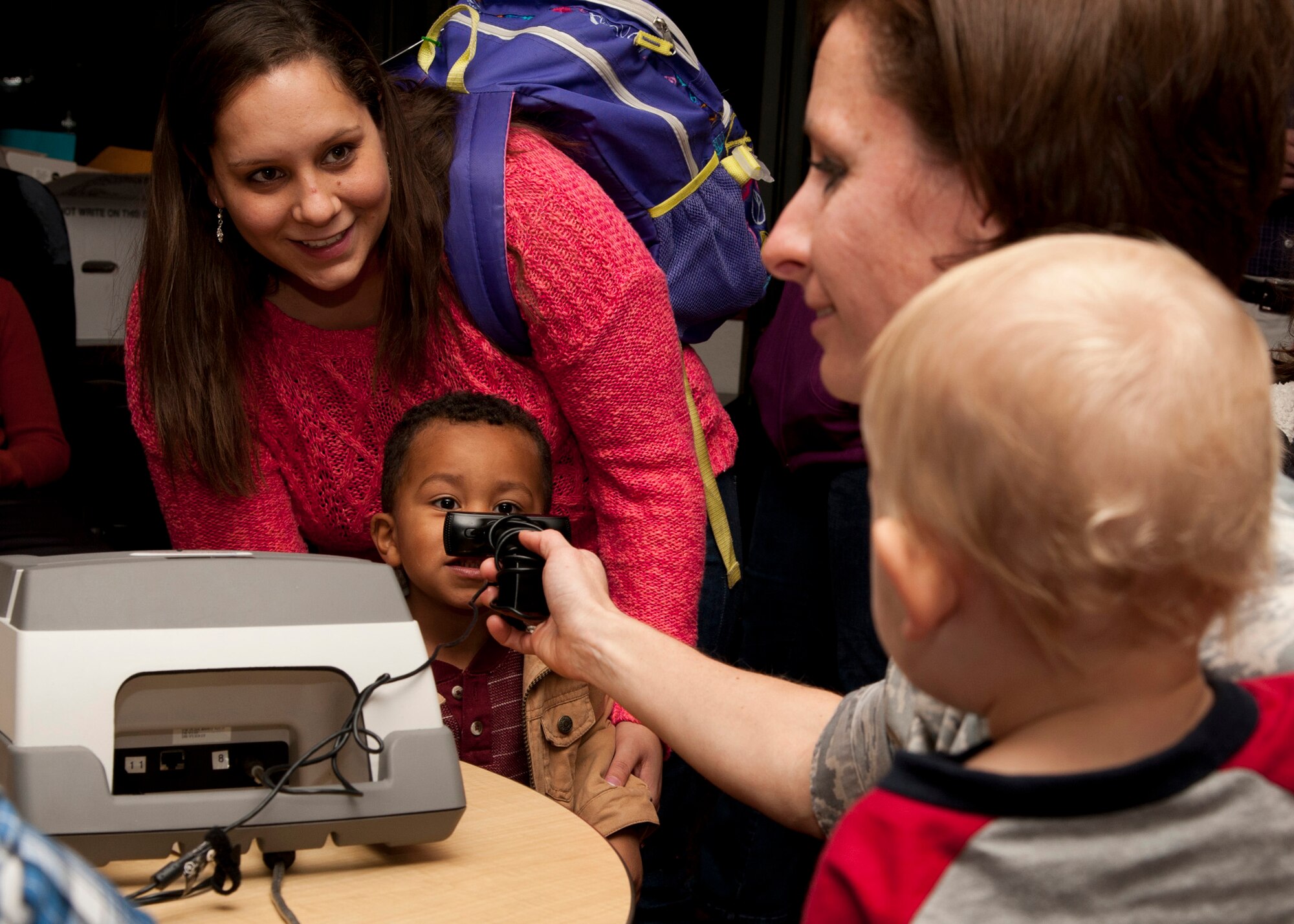 PETERSON AIR FORCE BASE, Colo. – Staff Sgt. Marie Phillips, North American Aerospace Defense Command emergency actions control, holds her son, Ivan, while getting his photograph taken for an emergency identification kit during Operation Safe Kids at the RP Lee Youth Center, Nov. 20. Operation Safe Kids is a program by the U.S. Secret Service where parents are provided identification kits of their children’s basic information, photo and fingerprints. If the child goes missing the parents can quickly provide the information to law enforcement agencies. (U.S. Air Force photo by Senior Airman Tiffany DeNault)
