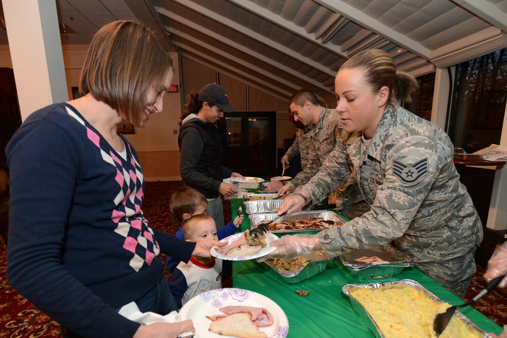 Staff Sgt. Jennifer Starr, 66th Security Forces Squadron specialist, serves dinner to Kim Pottratz during the November Hearts Apart that was held at the Minuteman Commons Nov. 19. (U.S. Air Force photo by Jerry Saslav)