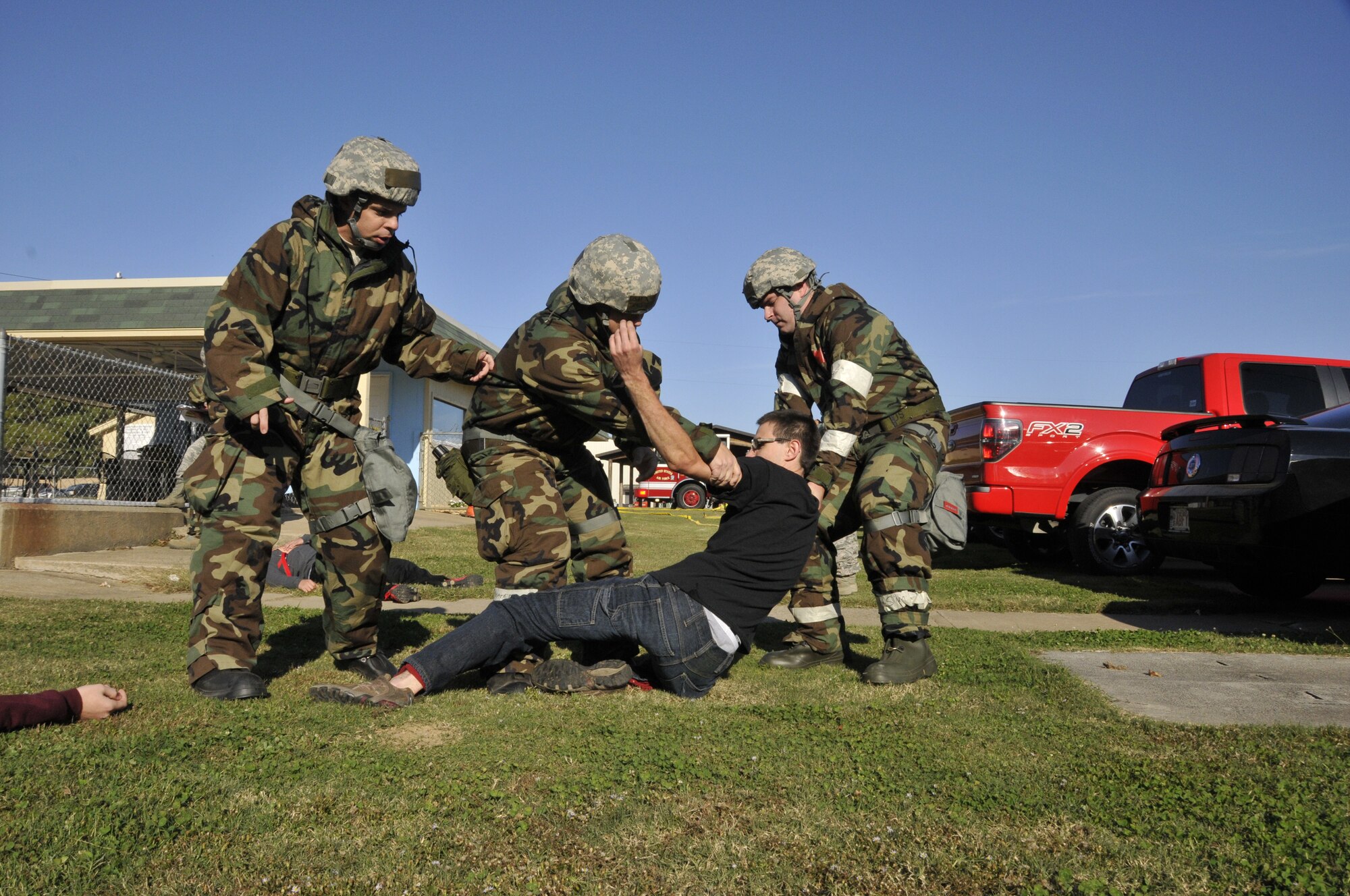 Airman Basic Aaron William, 188th Wing Student Flight member, role plays as a grief-stricken person who reacts violently to the scenario as three members of the 188th attempt to calm him down during a mass casualty exercise at Ebbing Air National Guard Base, Fort Smith, Ark., Nov. 2, 2014. The purpose of the exercise was to test Airmen’s ability to triage Airmen while facing possible attacks. (U.S. Air National Guard photo by Staff Sgt. John Suleski/Released)