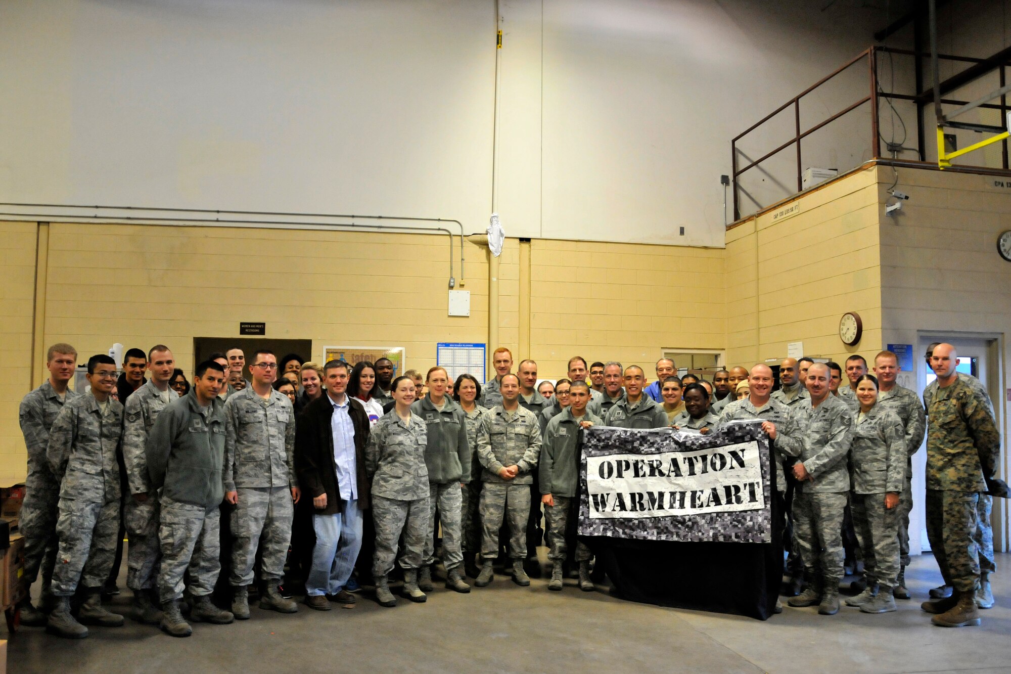 GOODFELLOW AIR FORCE BASE, Texas – Members of Team Goodfellow pose for a photo after Operation Warmheart inside the commissary Nov. 25. The 1st Sgt program runs all year and operates in three capacities: facilitate donations, distributions throughout the year and the holiday donation and distribution season. (U.S. Air Force photo/ Airman 1st Class Scott Jackson)