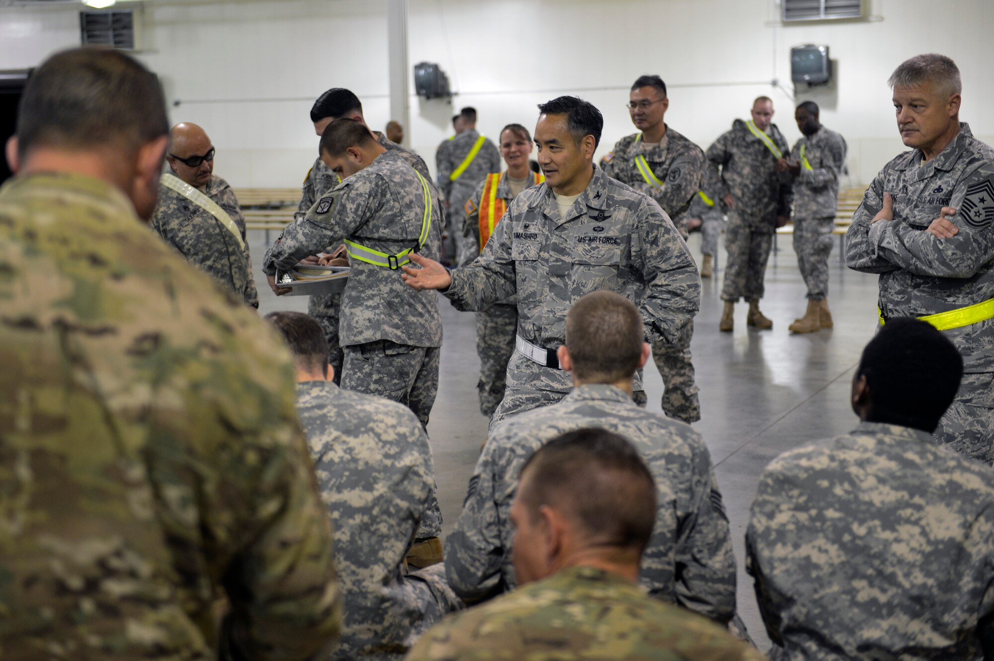 Col. David Kumashiro, 62nd Airlift Wing commander, welcomes home the 16 joint service members who spent time in West Africa supporting Operation United Assistance Nov. 25, 2014, at Joint Base Lewis-McChord, Wash. The personnel were transported to the Lewis North area of JBLM and housed in barracks separate from the rest of the installation. (U.S. Air Force photo/Staff Sgt. Russ Jackson)