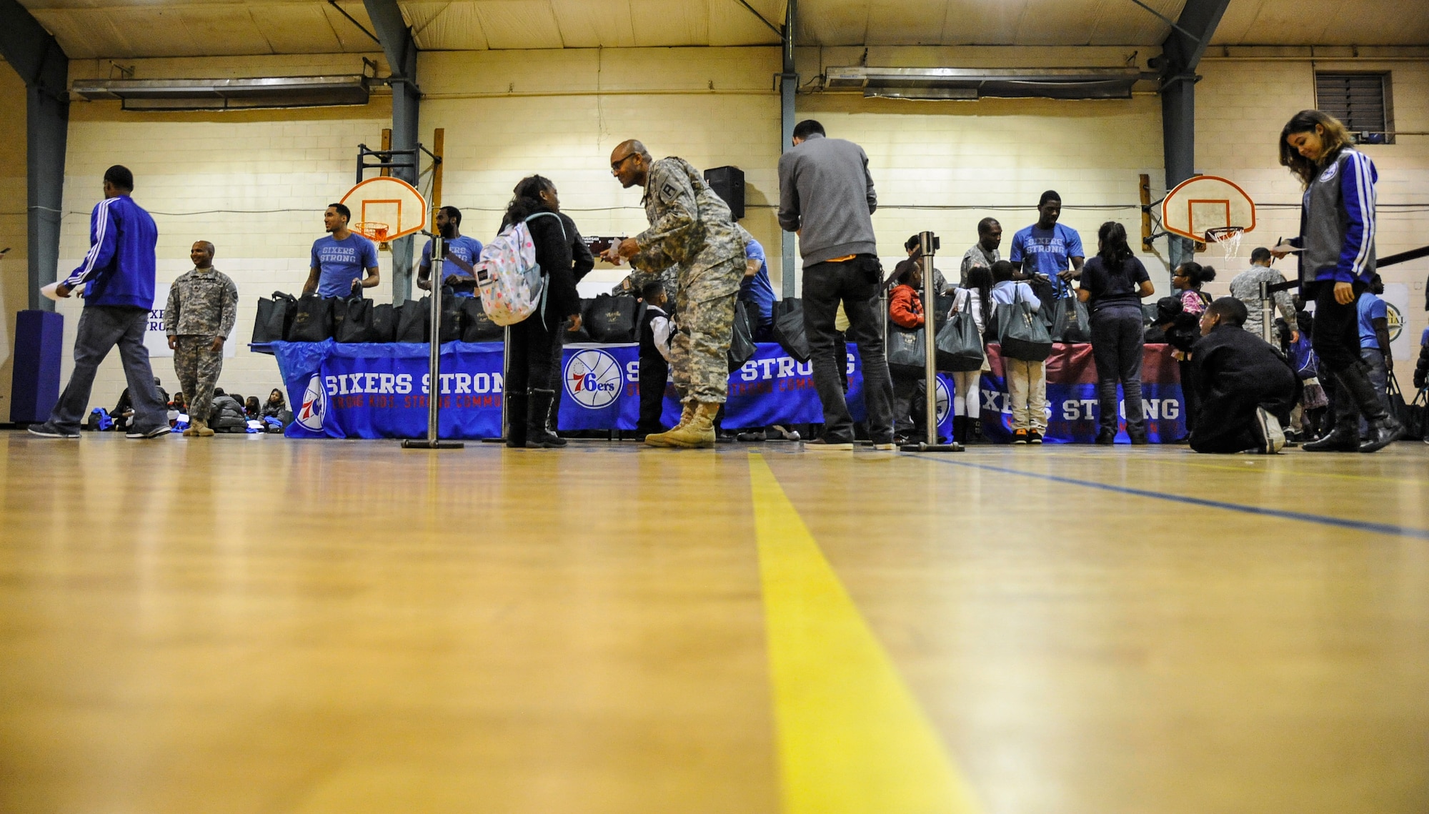 Service members from Joint Base McGuire-Dix-Lakehurst, New Jersey, and the Philadelphia 76ers teamed up to hand out 300 turkeys to area families at the Wissahickon Boys and Girls Club in Philadelphia Nov. 25, 2014. The event was a part of a Department of Defense initiative called Commitment to Service, which links the country’s premier athletes and military members to serve their communities with hopes of building strong and compassionate communities. (U.S. Air Force photo by Staff Sgt. Scott Saldukas/Released)