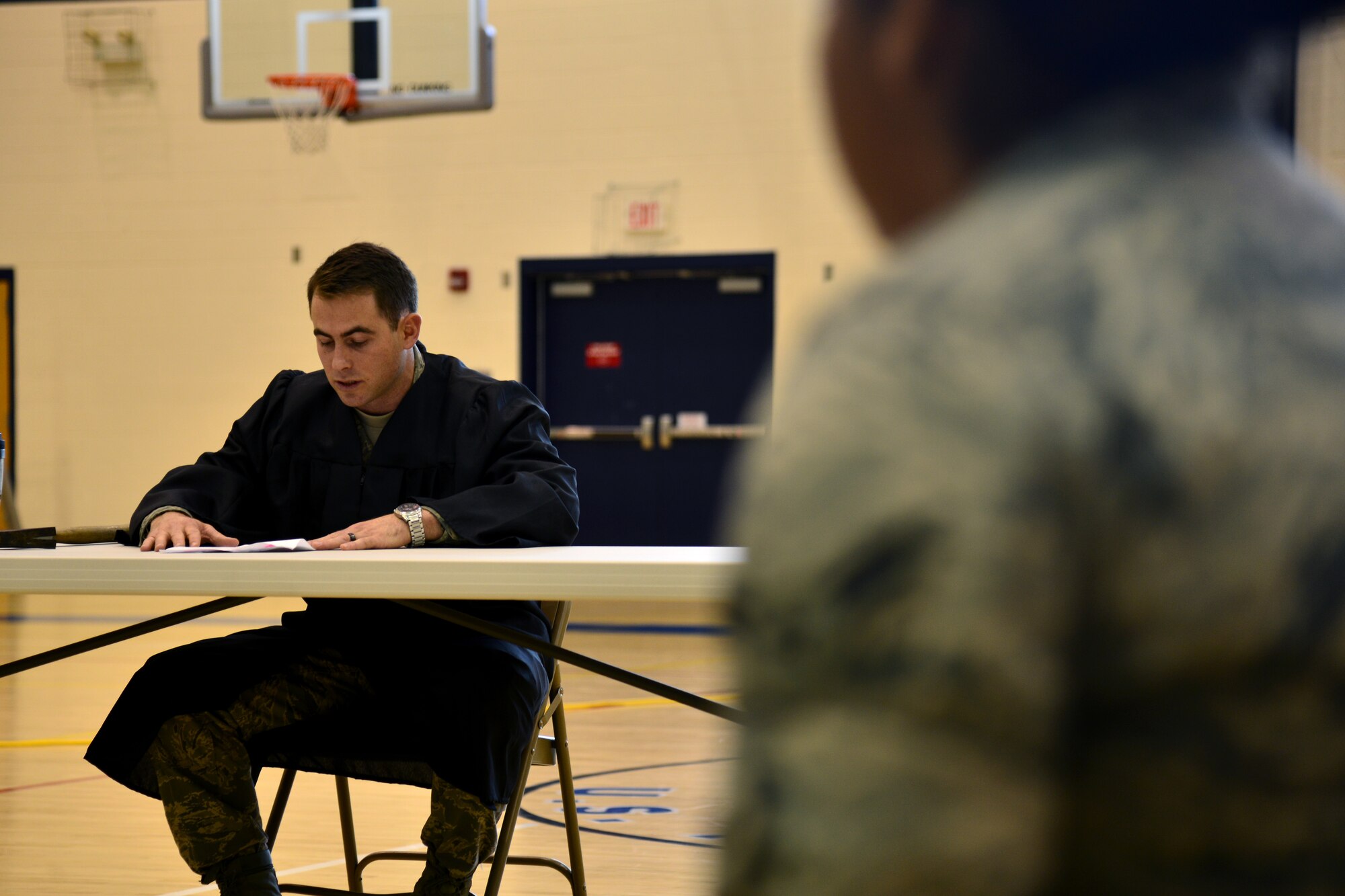 U.S. Air Force 2nd Lt. Conor Mulligan, 633rd Force Support Squadron fitness and sports officer in charge, reads instructions to a jury during a mock court-martial at Langley Air Force Base, Va., Nov. 21, 2014. During the simulated trial, Airmen experienced the proceedings of a sexual assault case from events leading to the assault to the verdict. (U.S. Air Force photo by Senior Airman Aubrey White/Released)