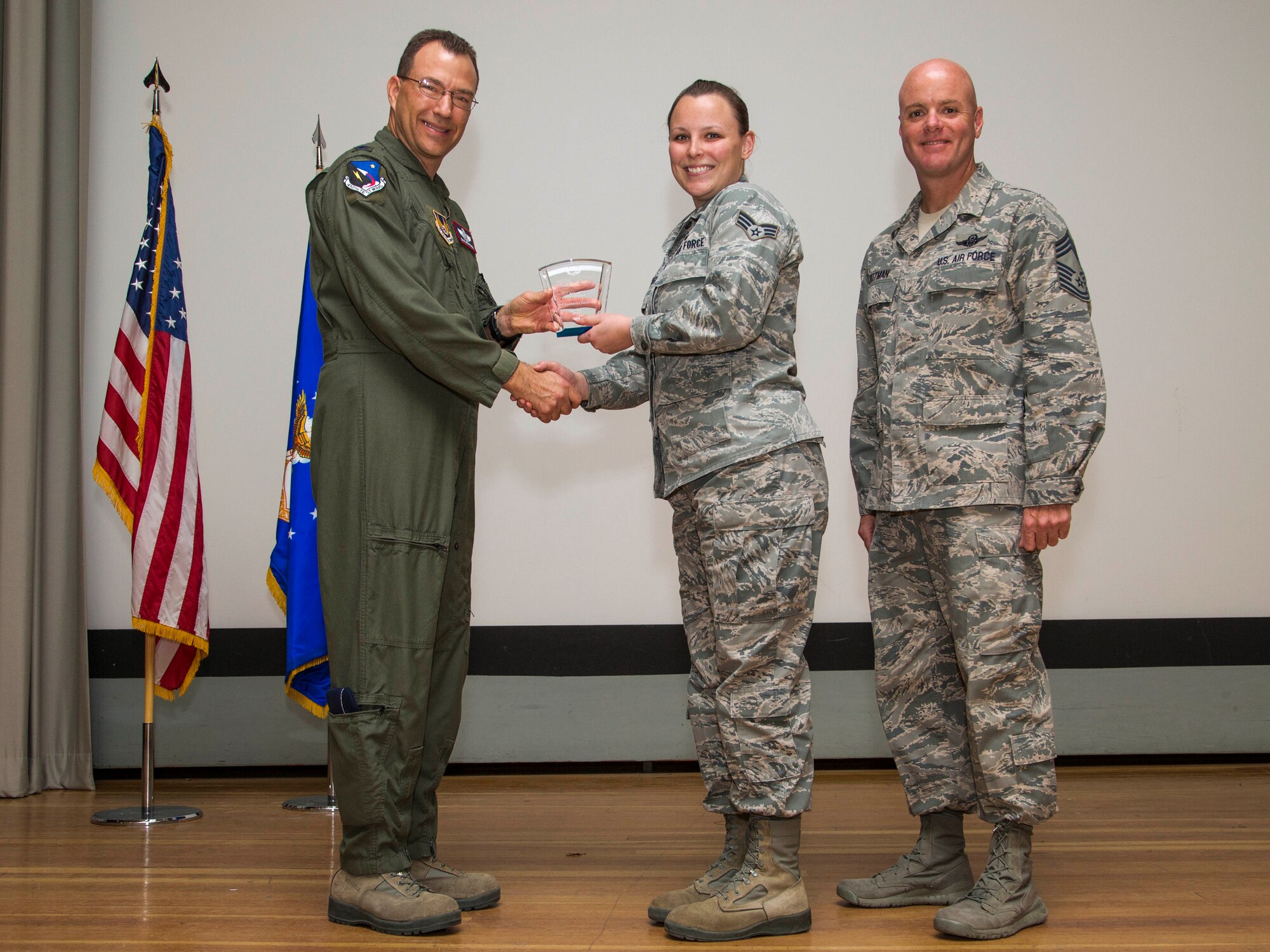 From left: Col. David Radomski, 412th Test Wing vice commander, presents the Airman of the Quarter award to Senior Airman Kassandra VanBeek, 412th Communications Squadron, as Chief Master Sgt. James Pittman, 412th Operations Group, looks on. (U.S. Air Force photo by Scott Dworkin)