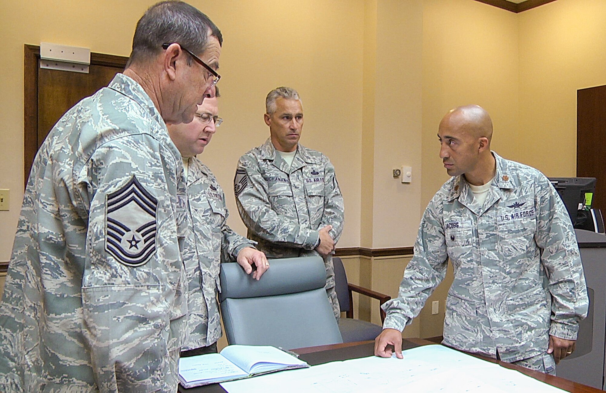 U.S. Air Force Maj. Charles Jacobs, right, detachment commander of the 202nd Engineering Installation Squadron, Georgia Air National Guard, meets with senior leaders of the squadron to discuss plans for an upcoming project, Robins Air Force Base, Ga., Nov. 4, 2014. Jacobs is a member of the Lumbee Indian tribe out of Robeson County, North Carolina. The tribe has more than 55,000 members with two of the members serving together in the Georgia Air National Guard at Robins Air Force Base. Jacobs and a fellow Airman are descendants of Henry Berry Lowry, a young Native American Revolutionist who rose up in 1865 to fight injustice being directed against his people who are the modern day Lumbee Indians. Lowry came to be known as the Indian Robin Hood for his exploits. (U.S. Air National Guard photo by Master Sgt. Roger Parsons/Released)