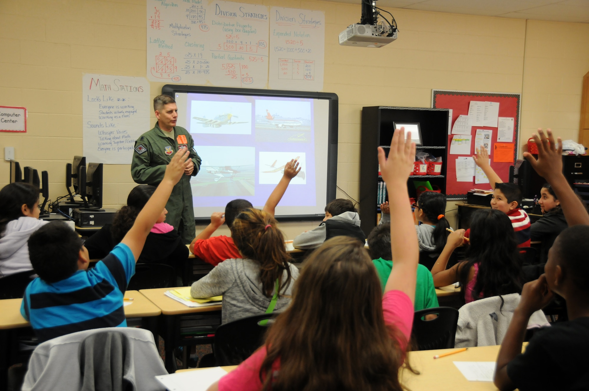 Lt. Col. Toby Brallier, 188th Wing pilot, conducts a presentation on his career as part of the Partners in Education program at Sutton Elementary school in Fort Smith, Ark., Nov. 6, 2014. Brallier is assigned to the 188th Operations Group. (U.S. Air National Guard photo by Airman 1st Class Cody Martin/Released)