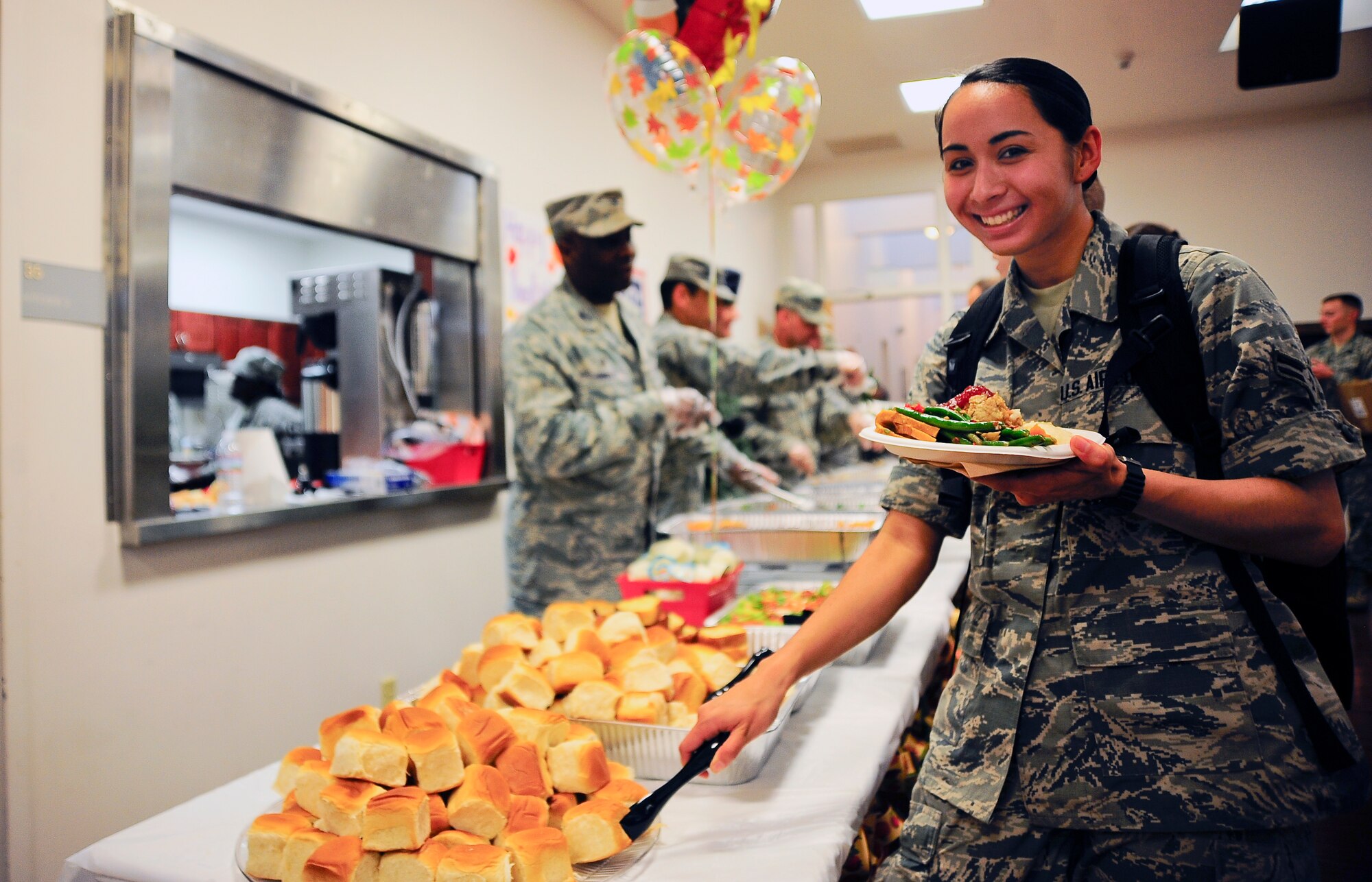 Airman 1st Class Danielle Conde, 6th Air Mobility Wing photojournalist, poses for a photo during the dorm resident Thanksgiving dinner at MacDill Air Force Base, Fla., Nov. 24, 2014. Due to the dining facility closure, private organizations on base teamed up with the local United Service Organization to put together a Thanksgiving feast for the dorm residents. (U.S. Air Force photo by Senior Airman Melanie Bulow-Gonterman/Released)  