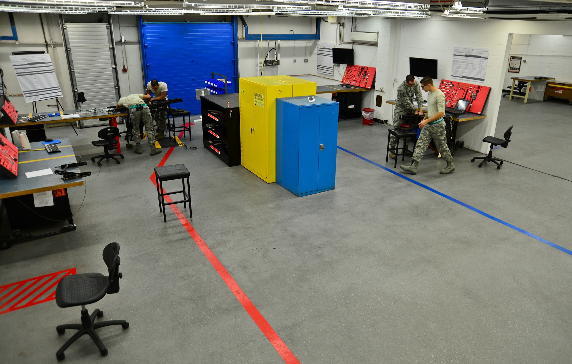 The 48th Component Maintenance Squadron egress crew completes 36-month ejection seat inspections Nov. 19, 2014, in their newly-transformed shop after an Air Force Smart Operations for the 21st Century event at Royal Air Force Lakenheath, England. Three stations are now set up on either side of the shop, streamlining the inspection process. (U.S. Air Force photo by Airman 1st Class Erin R. Babis/Released) 