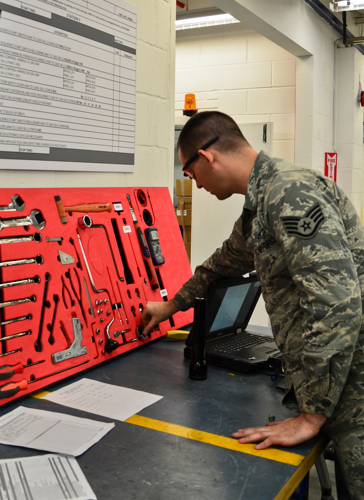 Staff Sgt. Kevin Mayo, 48th Component Maintenance Squadron aircrew egress systems craftsman, cleans up the workstation and consolidated toolkit after completing his task at Royal Air Force Lakenheath, England, Nov. 19, 2014. The 48th CMS surpassed their goal of decreasing the amount of time it takes to complete a 36-month inspection – from 39 hours down to an average of 22 hours per ejection seat. (U.S. Air Force photo by Airman 1st Class Erin R. Babis/Released)