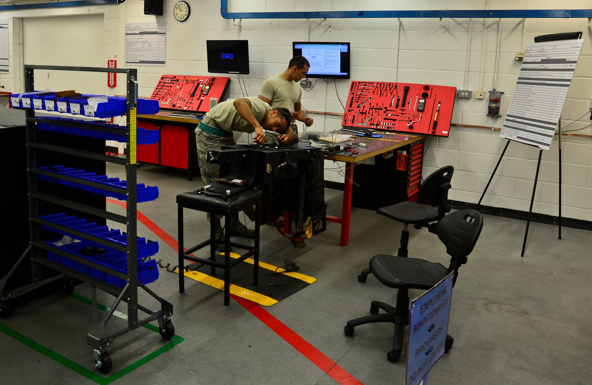 Senior Airmen Daniel Colon and Paul Matos, 48th Component Maintenance Squadron aircrew egress systems journeymen, work on an ejection seat rebuild for a 36-month inspection at Royal Air Force Lakenheath, England, Nov. 19, 2014. An Air Force Smart Operations for the 21st Century event was held to streamline operations and reduce wasted materials and manpower. (U.S. Air Force photo by Airman 1st Class Erin R. Babis/Released)