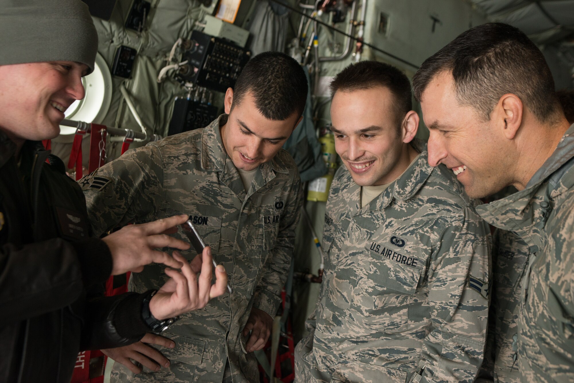 Staff Sgt. Andrew McIntosh, 71st Rescue Squadron, shows Airmen from the 336th Training Support Squadron and 336th Training Group a video of survival evasion resistance escape (SERE) High Altitude Low Opening (HALO) parachute training held the previous day during a C-130J Super Hercules orientation Nov. 20, 2014, at Fairchild Air Force Base, Wash. McIntosh is from Moody AFB, Georgia and was aboard the aircraft for upgrade training on the new additions to the C-130J model. (U.S. Air Force photo/Staff Sgt. Alexandre Montes)