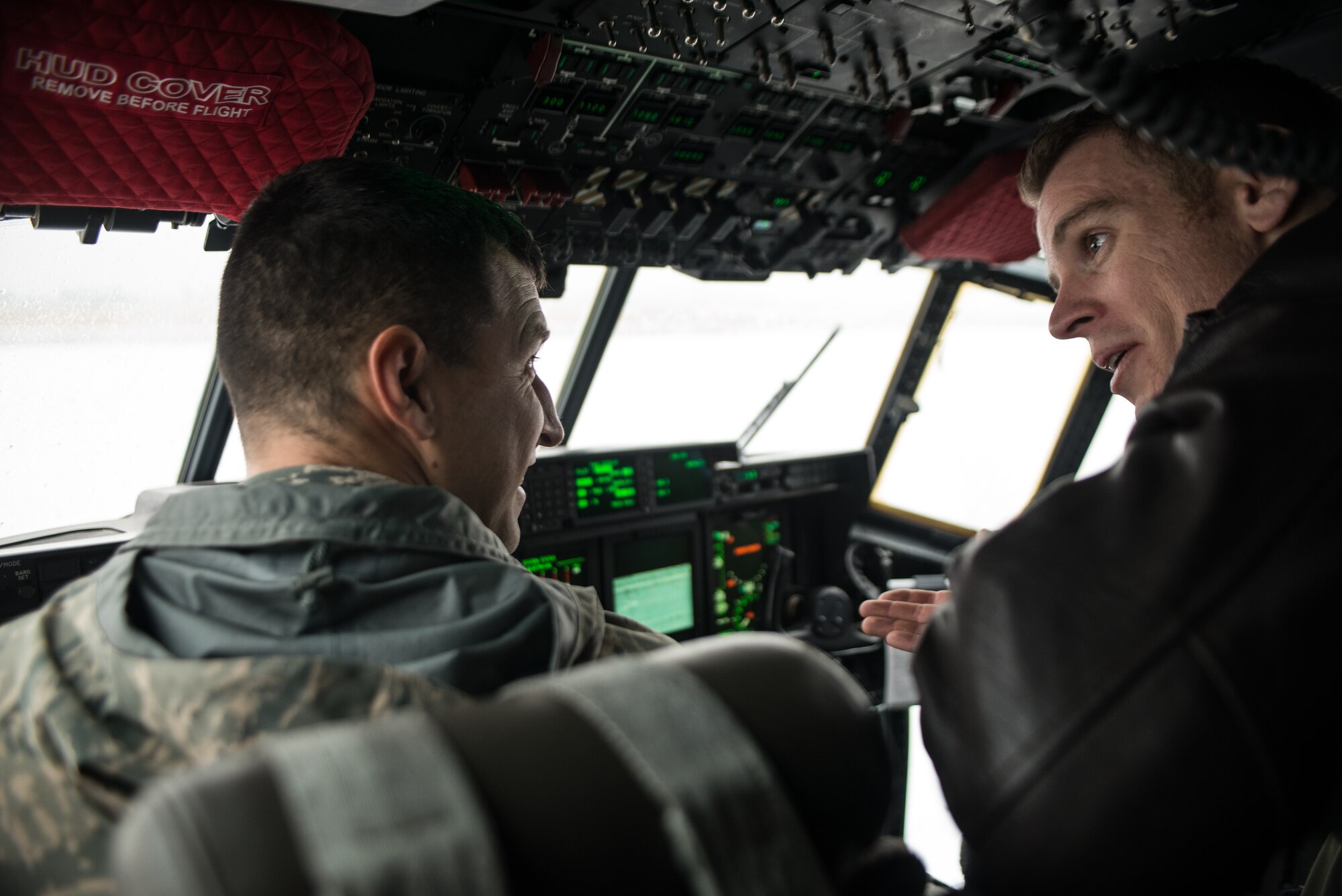 Lt. Colonel Andrew Reisenweber, 336th training Group, listens to Major Richard Bolton, 58th Special Operations Wing, speak about the newest specifications in the C-130J Super Hercules cockpit during an aircraft orientation Nov. 20, 2014, at Fairchild Air Force Base, Wash. The C130J is the newest model of the Hercules still in production. With the new updates, Airman are continuously learning and training to become more proficient on each of the update. (U.S. Air Force photo/Staff Sgt. Alexandre Montes)