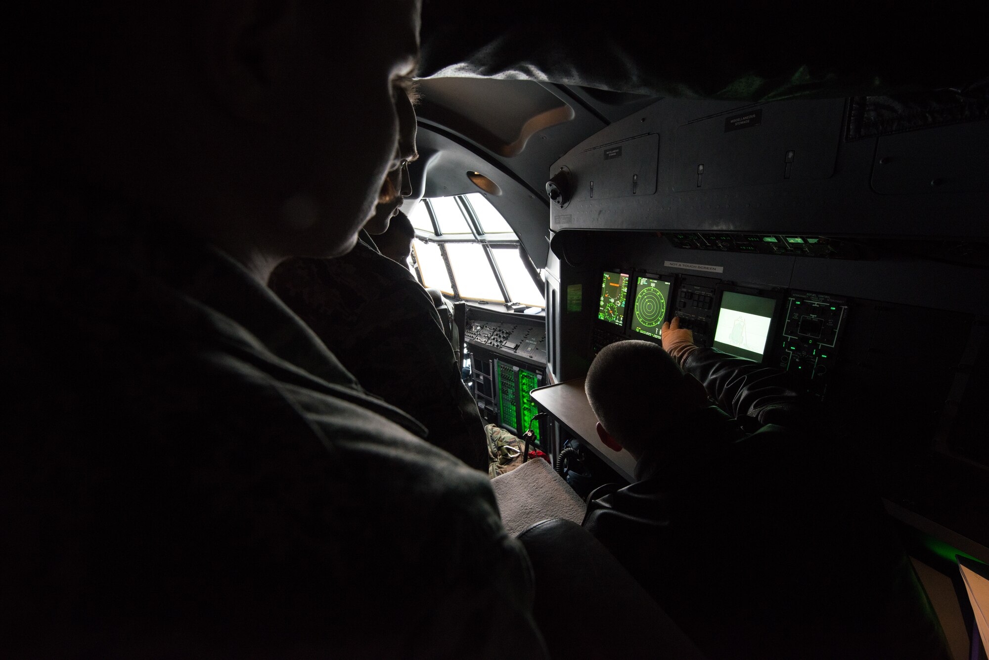 Lt. Colonel Daniel Leichssenring, 58th Operations Support Squadron, explains the different types of radar used aboard a C-130J Super Hercules during an orientation of the aircraft Nov. 20, 2014, at Fairchild Air Force Base, Wash. Leichssenring took time to walk-through the aircraft and talk to about its unique modification from the other c-130 models being used in across the Department of Defense.  (U.S. Air Force photo/Staff Sgt. Alexandre Montes)