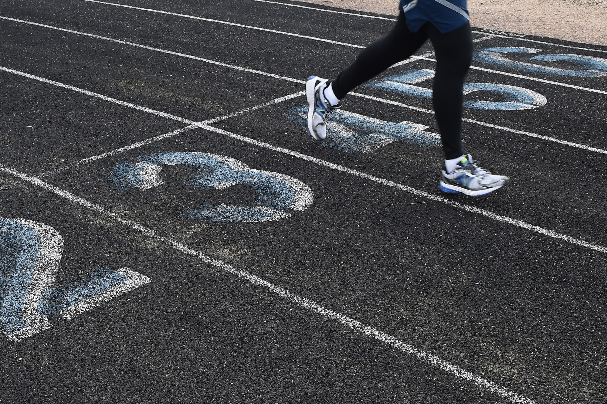 A Team Buckley member crosses the finish line during the eighth annual Turkey Trot 5K Nov. 25, 2014, on Buckley Air Force Base, Colo. The fitness center hosted the run as a way to promote camaraderie and holiday spirit. (U.S. Air Force photo by Airman 1st Class Emily E. Amyotte/Released)