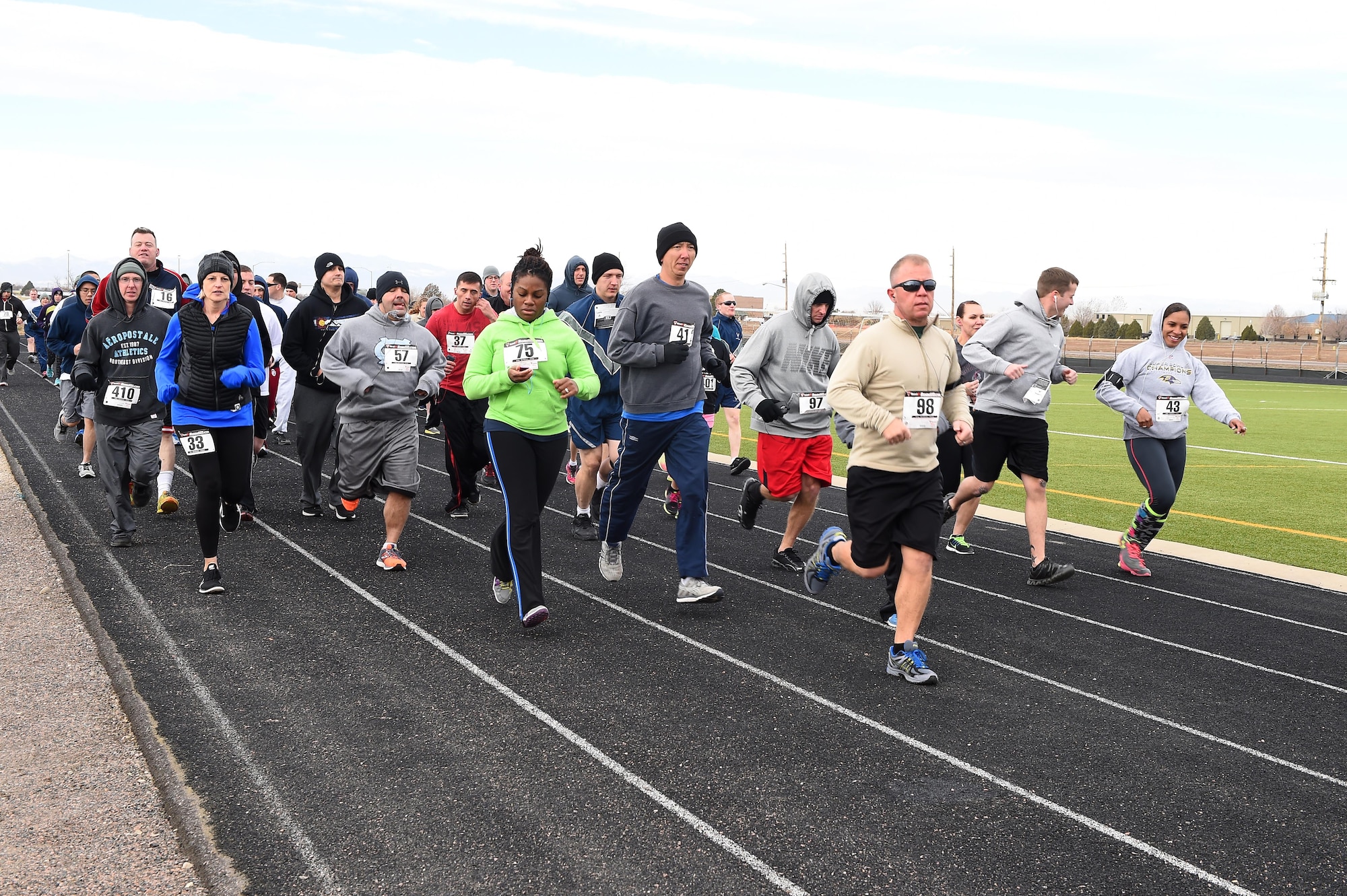 Team Buckley members take off at the beginning of the eighth annual Turkey Trot 5K Nov. 25, 2014, on Buckley Air Force Base, Colo. The first to finish in each age group won a turkey to cook for Thanksgiving. (U.S. Air Force photo by Airman 1st Class Emily E. Amyotte/Released)