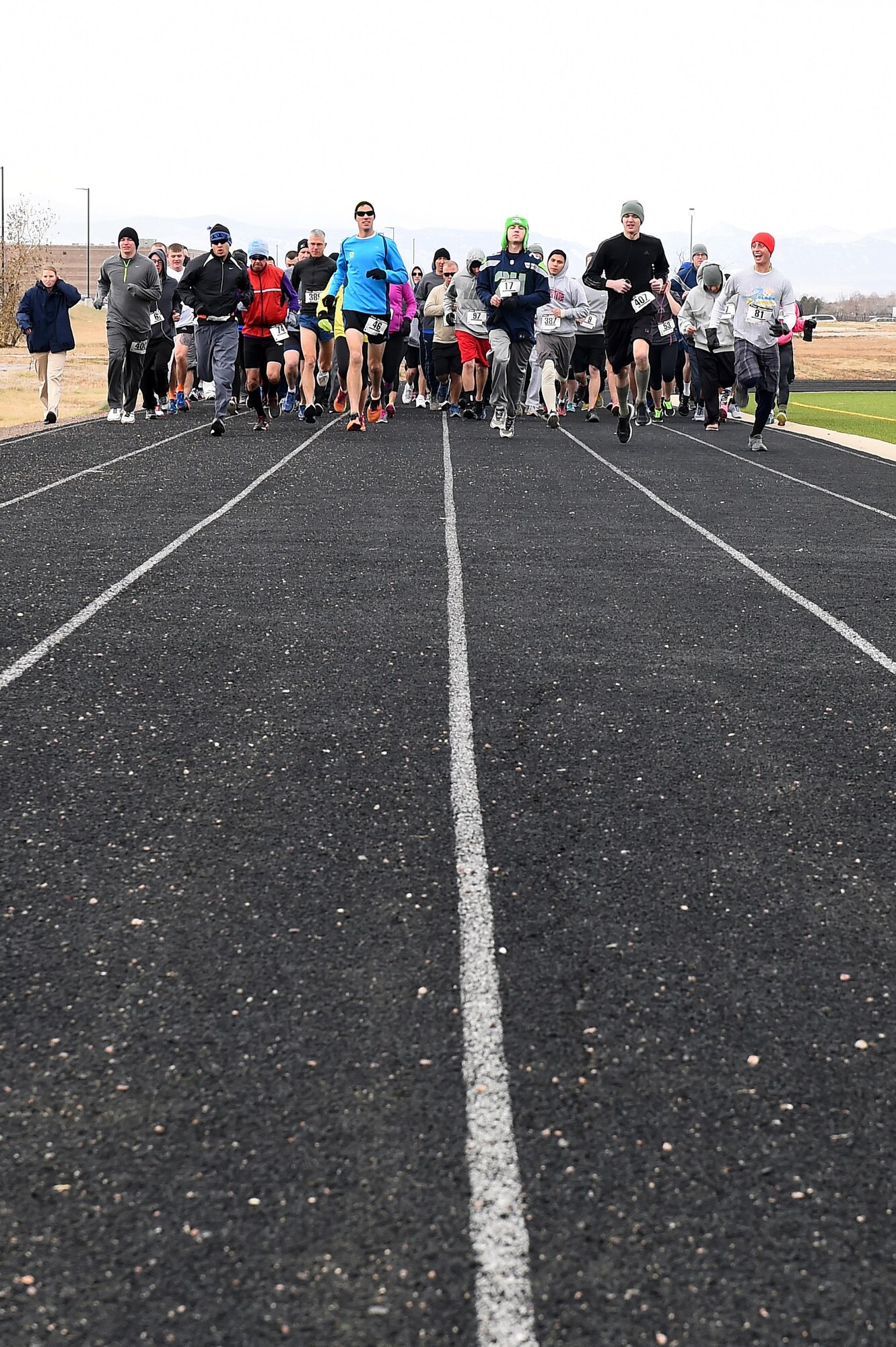 Team Buckley members take off at the beginning of the eighth annual Turkey Trot 5K Nov. 25, 2014, on Buckley Air Force Base, Colo. The fitness center hosted the run as a way to promote camaraderie and holiday spirit. (U.S. Air Force photo by Airman 1st Class Emily E. Amyotte/Released)