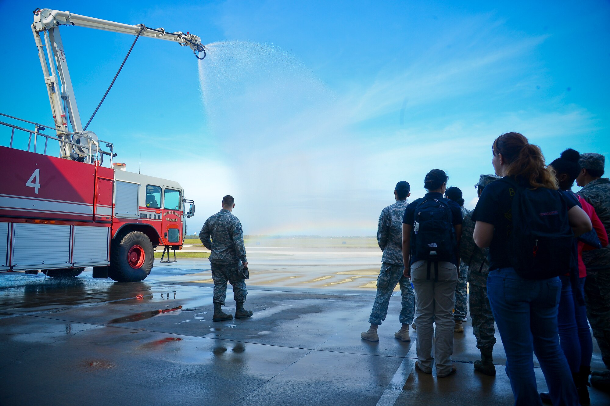 The 6th Civil Engineering Squadron firefighters show off the capabilities of their fire truck to a group during the Big for a Day event at MacDill Air Force Base, Fla., Nov. 24, 2014. More than 60 military members volunteered for the event.  (U.S. Air Force photo by Airman 1st Class Ned T. Johnston/Released)