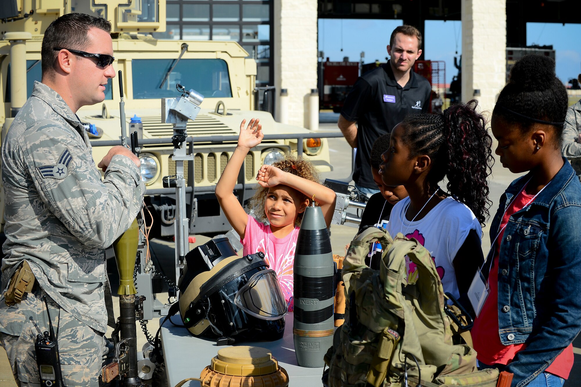 Senior Airman John J. Barr IV, 6th Civil Engineer Squadron explosive ordnance disposal technician, speaks to a group during the Big for a Day event at MacDill Air Force Base, Fla., Nov. 24, 2014. This was the 14th year Big Brother Big Sister of Tampa Bay partnered with MacDill to host the event. (U.S. Air Force photo by Airman 1st Class Ned T. Johnston/Released)