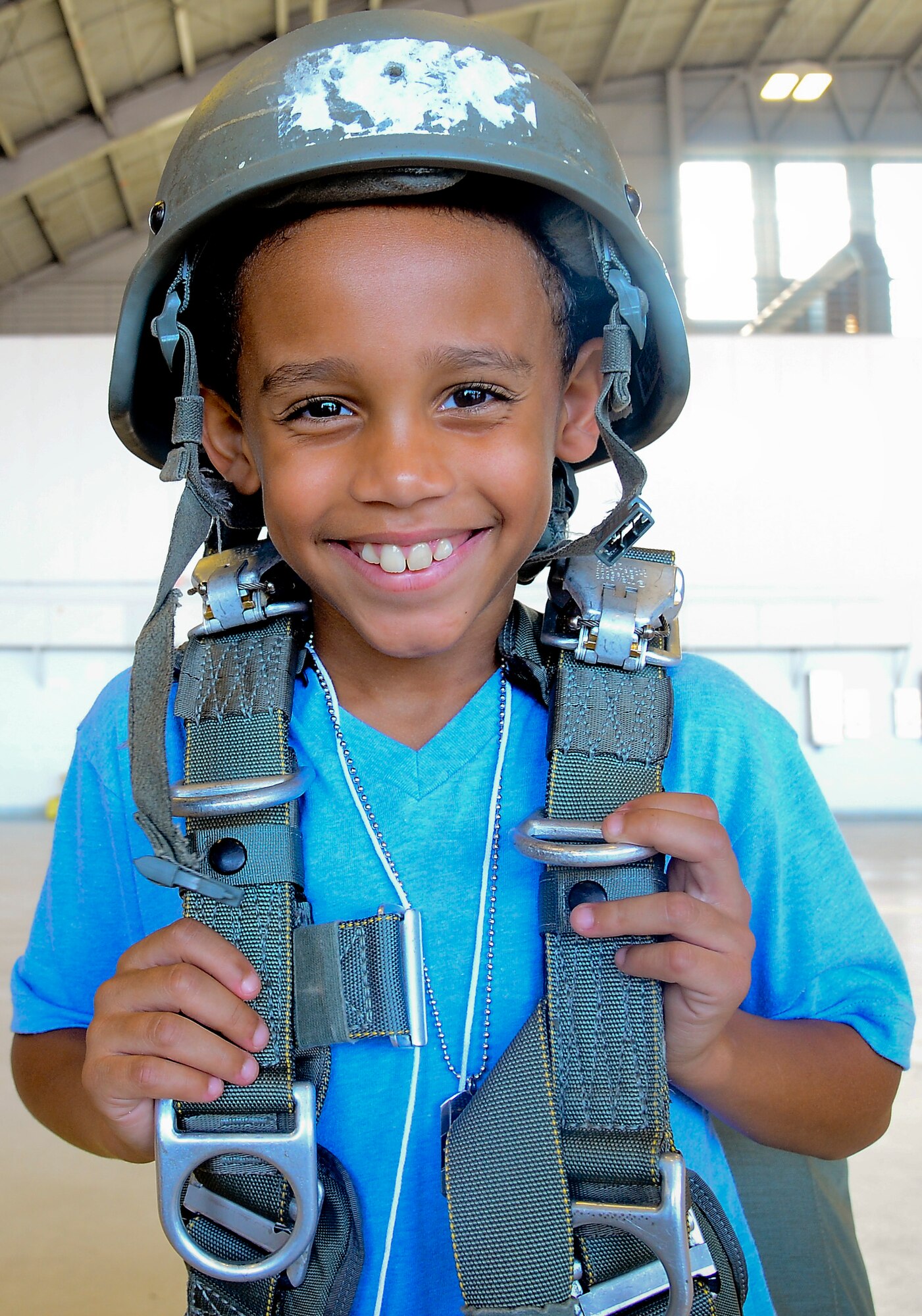 A “little” poses for a photo in static line parachute jump gear during the Big for a Day event at MacDill Air Force Base, Fla., Nov. 24, 2014. The event provided the little with an inside look into daily military operations.  (U.S. Air Force photo by Airman 1st Class Ned T. Johnston/Released)