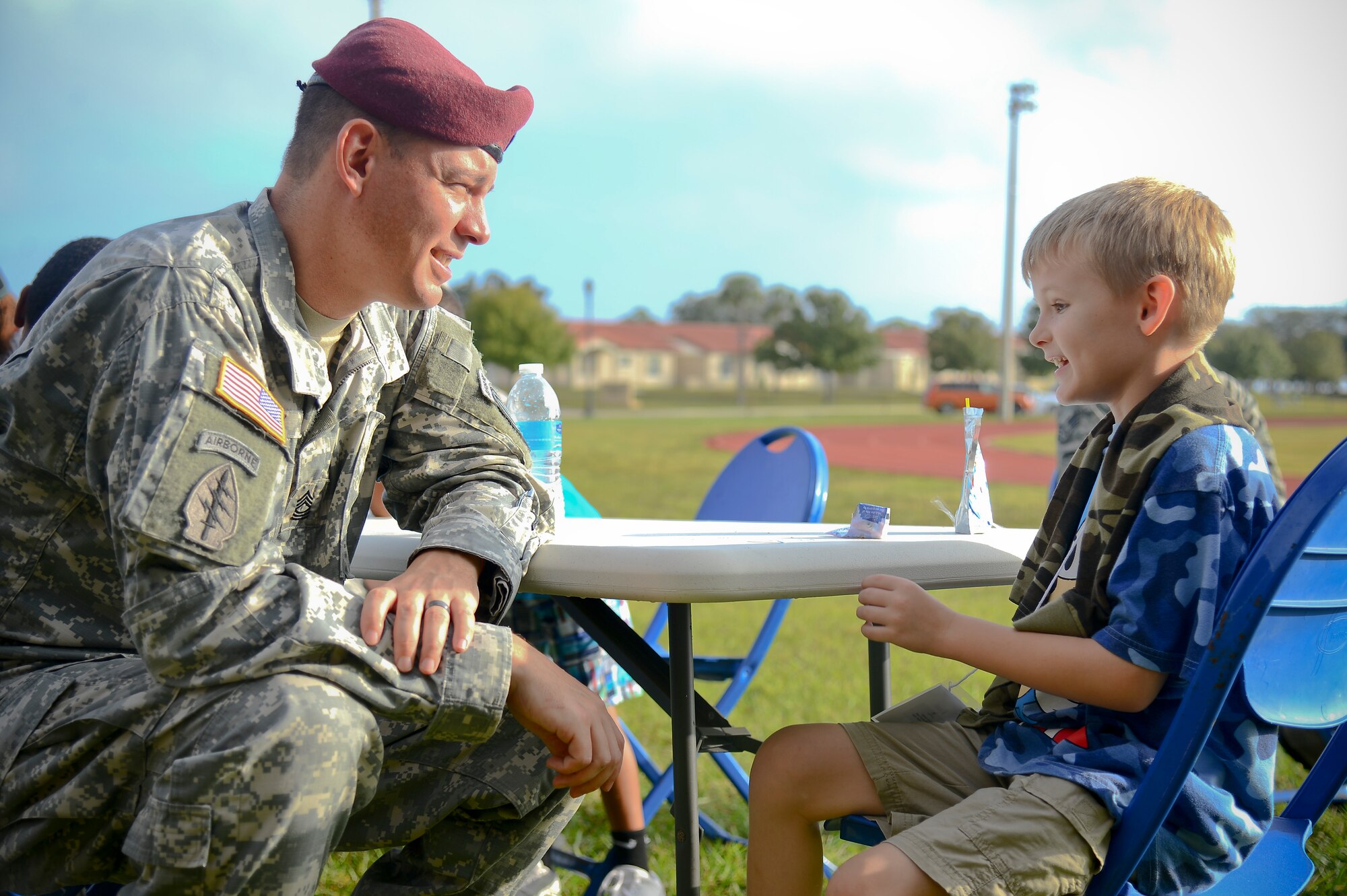 A member of Team MacDill sits with his “little” before the Big for a Day event at MacDill Air Force Base, Fla., Nov. 24, 2014. More than 60 military members volunteered for the event. (U.S. Air Force photo by Airman 1st Class Ned T. Johnston/Released)