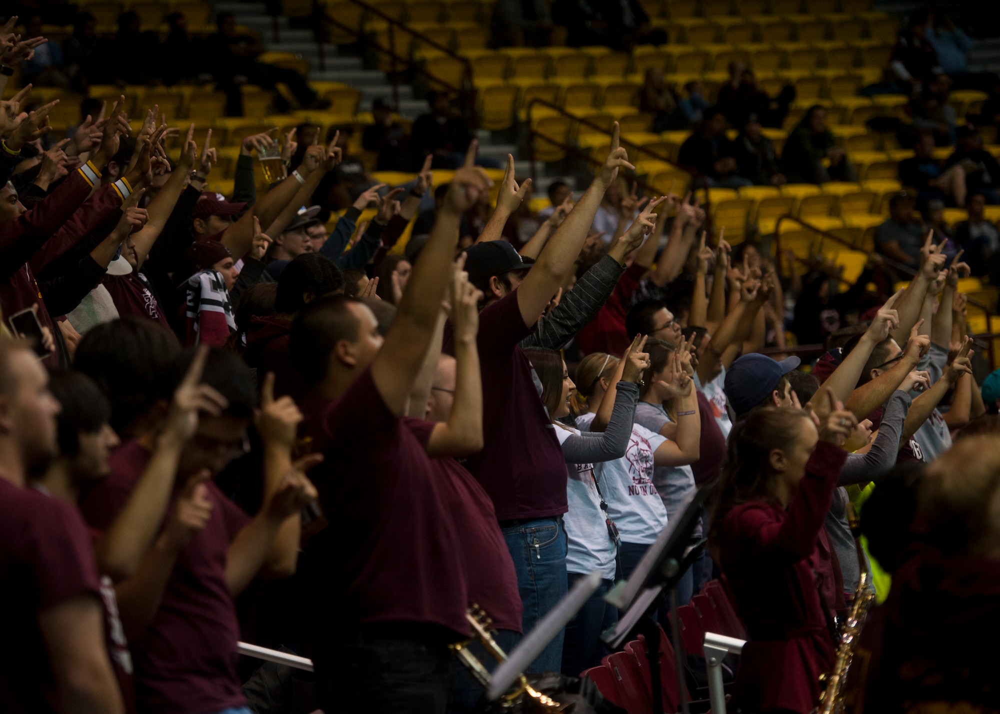 New Mexico State Aggies student section hold up their hands for luck at the Pan American Center in Las Cruces, N.M., Nov. 19. The Aggies compete in the Western Athletic Conference alongside several other schools in the region. Airmen can drive to the Pan American Center just an hour away from Holloman Air Force Base to enjoy the excitement of a live game atmosphere and to cheer on a team that’s appeared in the NCAA tournament the last three years running. (U.S. Air Force photo by Senior Airman Daniel E. F. Liddicoet/Released)