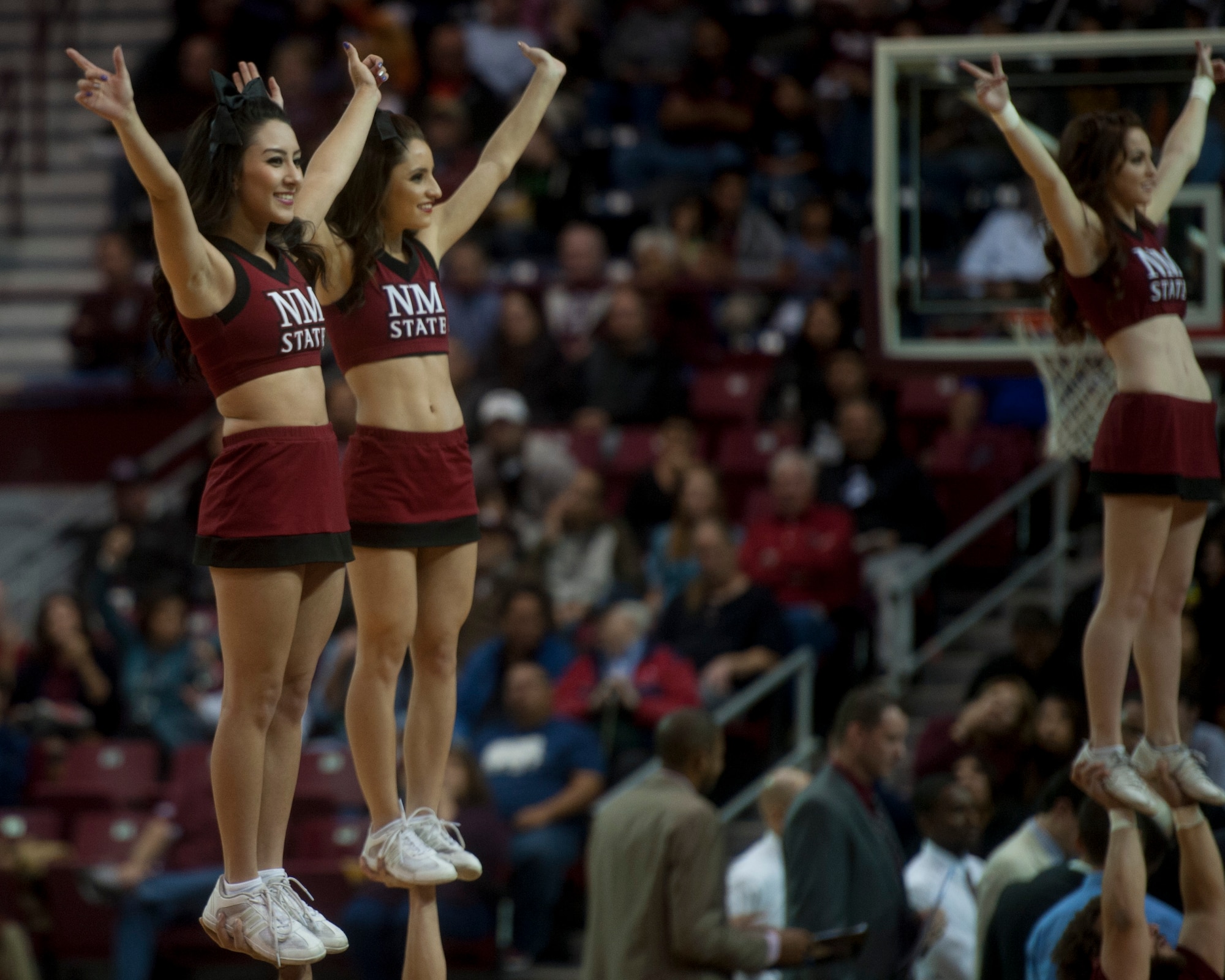 New Mexico State Aggies cheerleaders perform during an intermission at the Pan American Center in Las Cruces, N.M., Nov. 19. The Aggies compete in the Western Athletic Conference alongside several other schools in the region. Airmen can drive to the Pan American Center just an hour away from Holloman Air Force Base to enjoy the excitement of a live game atmosphere and to cheer on a team that’s appeared in the NCAA tournament the last three years running. (U.S. Air Force photo by Senior Airman Daniel E. F. Liddicoet/Released)