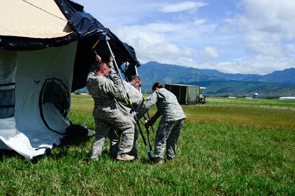 Members from the Joint Task Force-Bravo U. S. Southern Command Situational Assessment Team work together to set up a Deployable Rapid Assembly Shelter during air load and fly-away training on Soto Cano Air Base, Honduras, Nov. 25, 2014.  The members of the S-SAT received training on setting up a Pre-Positioned Expeditionary Assistance Kit to help prepare the team respond efficiently to humanitarian assistance and disaster response situations throughout U.S. Southern Command’s area of responsibility.    The training focused on S-SAT familiarization, hands on training and a fly-away event between JTF-Bravo S-SAT personnel, Army Forces Battalion, and 1-228th Aviation Regiment in preparation for an upcoming exercise. (U.S. Air Force photo/Tech. Sgt. Heather Redman)