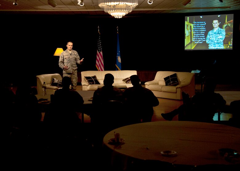 PETERSON AIR FORCE BASE, Colo. – Capt. Travis Black, 21st Logistics Readiness Squadron quality assurance officer in charge, tells his story of saving a girl’s life by donating his bone marrow during Storytellers at the Club, Nov. 21, 2014. Storytellers is a live event where fellow Airmen share their stories of resilience, motivation and professional pride in a relaxing environment that allows the audience to connect and learn. (Air Force photo by Senior Airman Tiffany DeNault)