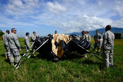 Members from the Joint Task Force-Bravo U. S. Southern Command Situational Assessment Team learn to set up a Deployable Rapid Assembly Shelter during air load and fly-away training on Soto Cano Air Base, Honduras, Nov. 25, 2014.  The members of the S-SAT received training on setting up a Pre-Positioned Expeditionary Assistance Kit to help prepare the team respond efficiently to humanitarian assistance and disaster response situations throughout U.S. Southern Command’s area of responsibility.  The training focused on S-SAT familiarization, hands on training and a fly-away event between JTF-Bravo S-SAT personnel, Army Forces Battalion, and 1-228th Aviation Regiment in preparation for an upcoming exercise. (U.S. Air Force photo/Tech. Sgt. Heather Redman)