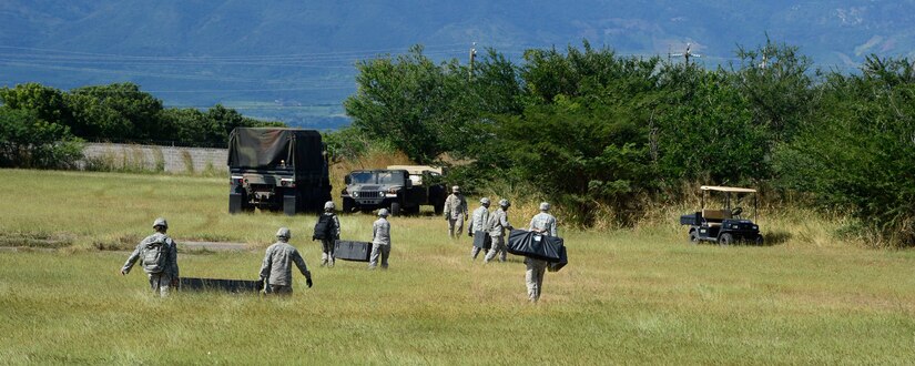 Members from the Joint Task Force-Bravo U. S. Southern Command Situational Assessment Team move equipment from a CH-47 Chinook landing zone at the Warrior Ramp during air load and fly-away training on Soto Cano Air Base, Honduras, Nov. 25, 2014.  The members of the S-SAT received training on setting up a Pre-Positioned Expeditionary Assistance Kit to help prepare the team respond efficiently to humanitarian assistance and disaster response situations throughout U.S. Southern Command’s area of responsibility.  The PEAK is designed to provide sustainable, essential services in the first 72 hours after a disaster event.  The training focused on S-SAT familiarization, hands on training and a fly-away event between JTF-Bravo S-SAT personnel, Army Forces Battalion, and 1-228th Aviation Regiment in preparation for an upcoming exercise.  (U.S. Air Force photo/Tech. Sgt. Heather Redman)