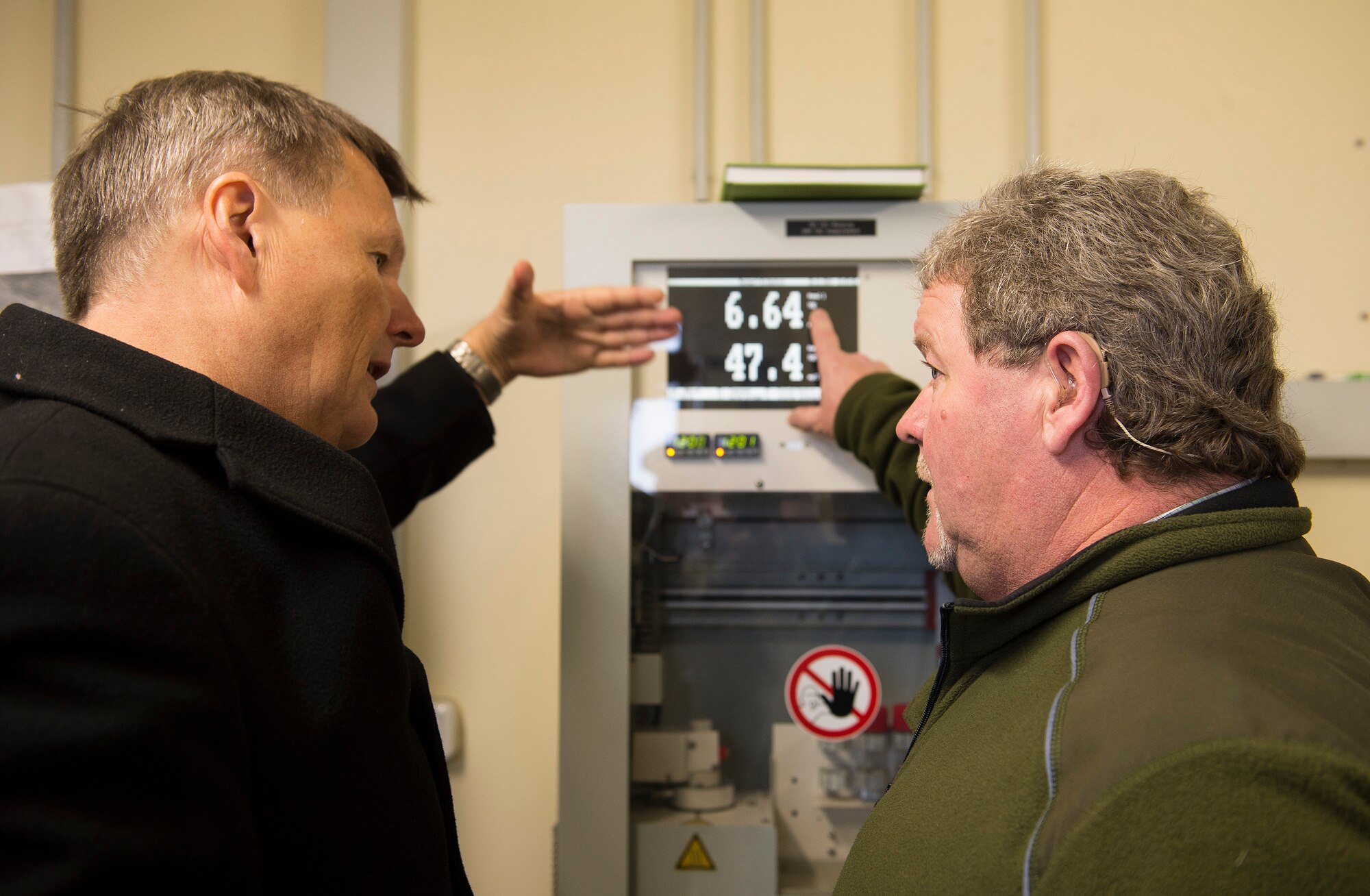 Dr. Ulrich Kleemann, SGD-Nord president, left, discusses water treatment processes with Peter Thiel, 52nd Civil Engineer Squadron waste water treatment foreman, Nov. 20, 2014, at Spangdahlem Air Base, Germany. Kleemann toured the base to discuss the wing’s continuing commitment to responsible stewardship of the environment and prospects for partnering with SGD-Nord, the environmental protection organization for the Rhineland-Pfalz region. (U.S. Air Force photo by Staff Sgt. Chad Warren/Released)