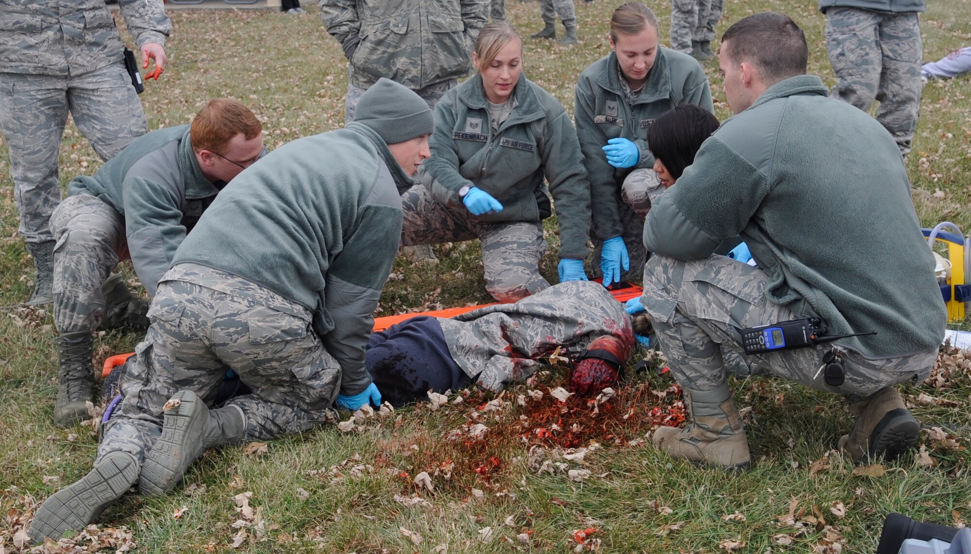WHITEMAN AIR FORCE BASE, MO—Members of the 509th Medical Group treats an amputee patient during an patient during a motor vehicle accident exercise at Whiteman Air Force Base, Mo., Nov. 21, 2014. The medics are preparing a log roll and securing the patient onto a long spine board. (U.S. Air Force photo by Staff Sgt. Alexandra M. Boutte/Released)