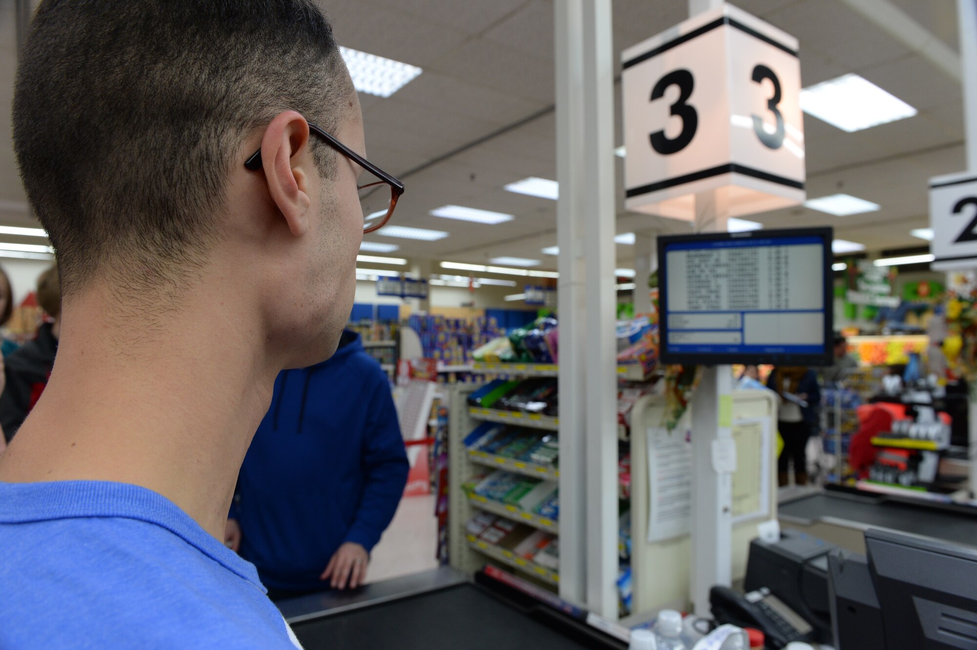 U.S. Air Force Senior Airman Andres Gomez, a 52nd Aerospace Medical Squadron bio-environmental engineering technician, watches the total price of his cart calculate on a screen during the Commissary Sweep Nov. 20, 2014, at the base commissary. The Commissary Sweep pitted five contestants against each other during to compete for a $150 gift card and a cart full of groceries. (U.S. Air Force photo by Airman 1st Class Dylan Nuckolls/Released)