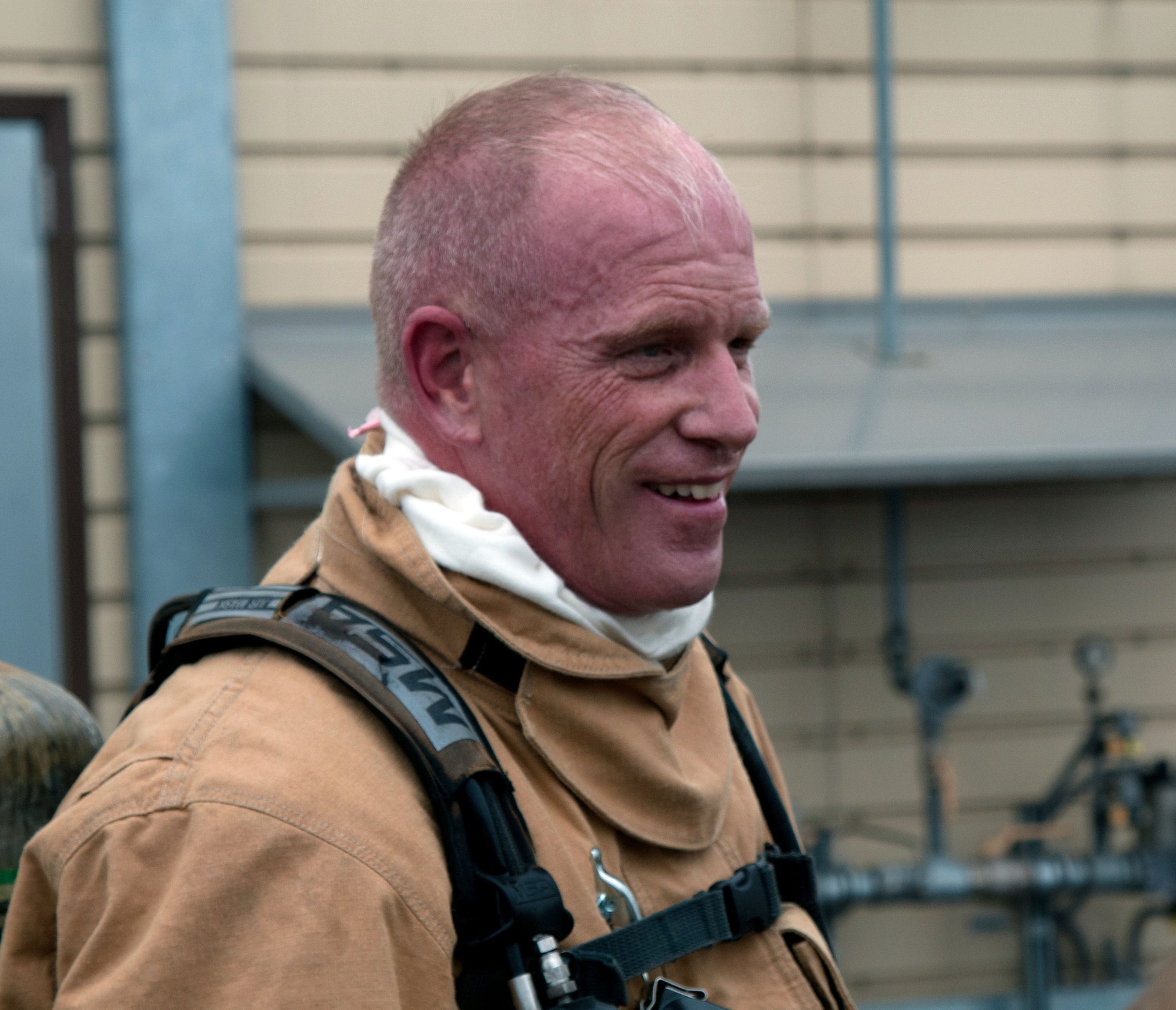 Chief Master Sgt. Frank H. Batten III, 86th Airlift Wing command chief, takes a rest after going through a burn house training scenario at Ramstein Air Base, Germany, Nov. 19, 2014. Batten participated in a burn house training scenario alongside Brig. Gen. Patrick X. Mordente, 86th AW commander, and firefighters assigned to the 86th Civil Engineer Squadron. The burn house training allows firefighters to experience going into a live fire in a controlled environment. (U.S. Air Force photo/Senior Airman Timothy Moore)